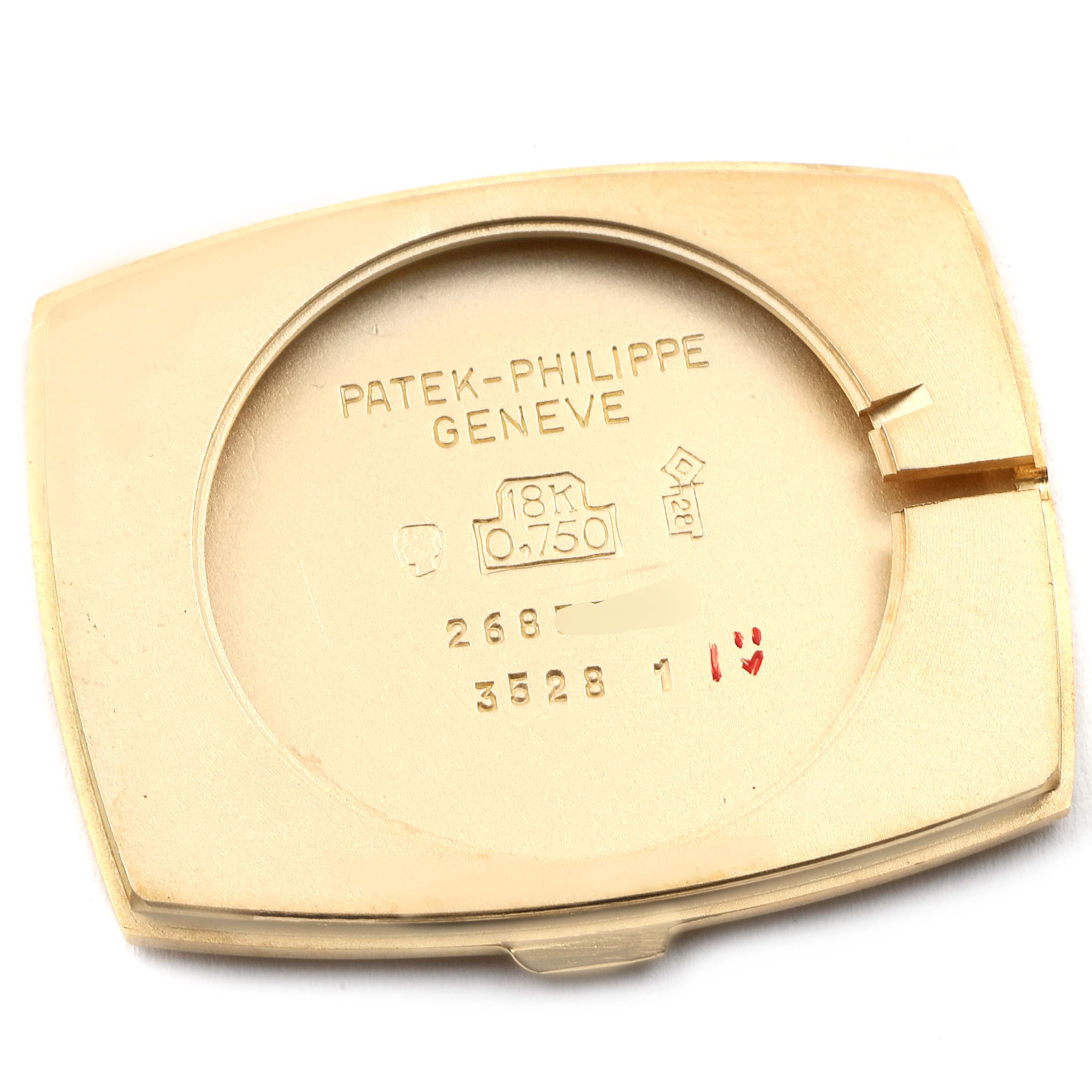 The image shows the back cover of a vintage Patek Philippe watch, displaying engravings and markings.