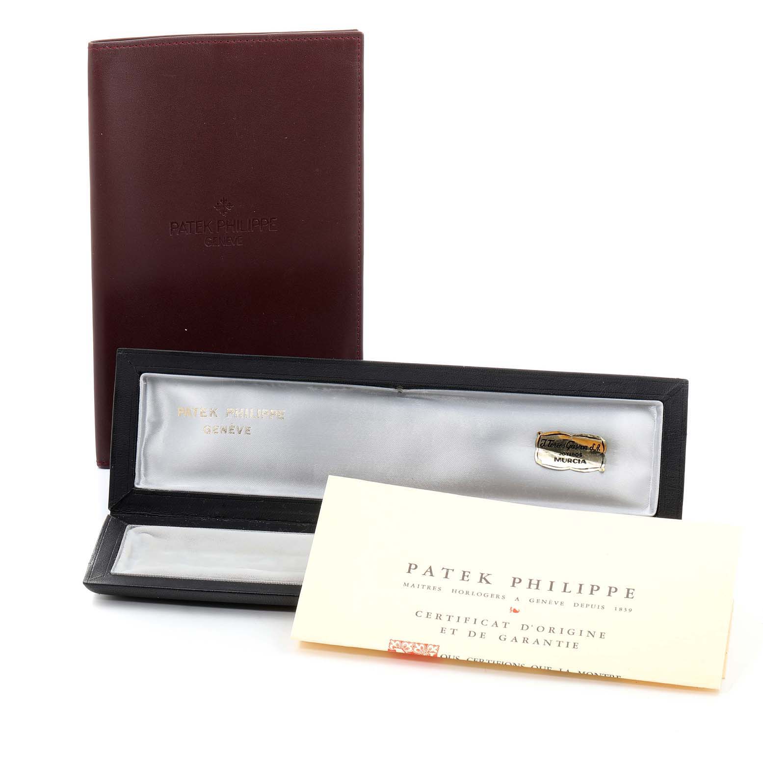 The image shows the packaging, booklet, and certificate for a Vintage Patek Philippe watch.