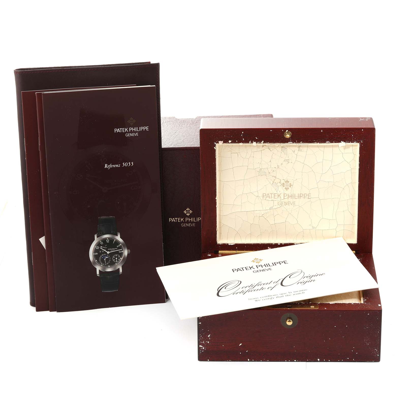 This image shows the packaging, certificate, brochures, and presentation box for the Patek Philippe Complications 5055J-001 Men
s Yellow Gold White Dial 5055J-001 Men
s Yellow Gold White Dial model watch.