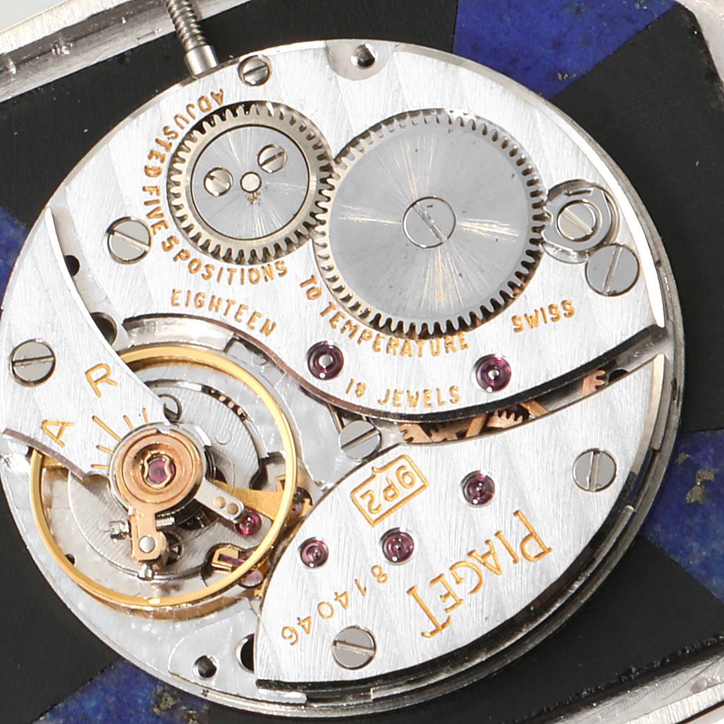 The image shows a close-up angle of the internal mechanism of the Piaget 9795 Women
s White Gold Blue Dial 9795 Women
s White Gold Blue Dial 9795 model White Gold Onyx Lapis Lazuli Dial Diamond Vintage Cocktail Watch.
