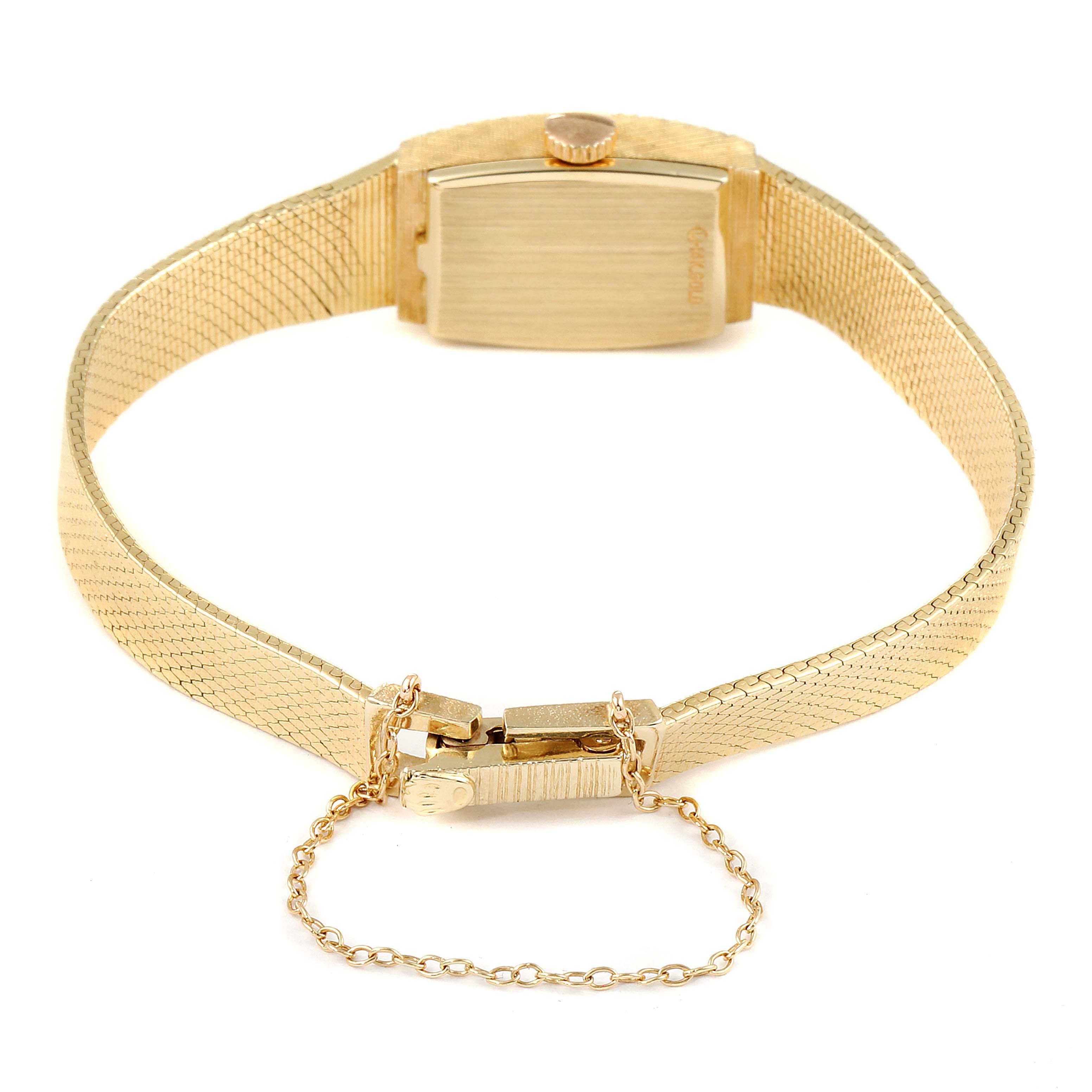 The image shows the back side of the Rolex Cocktail  Women's Yellow Gold Champagne Dial  Women's Yellow Gold Champagne Dial watch, highlighting the clasp, chain, and part of the bracelet.