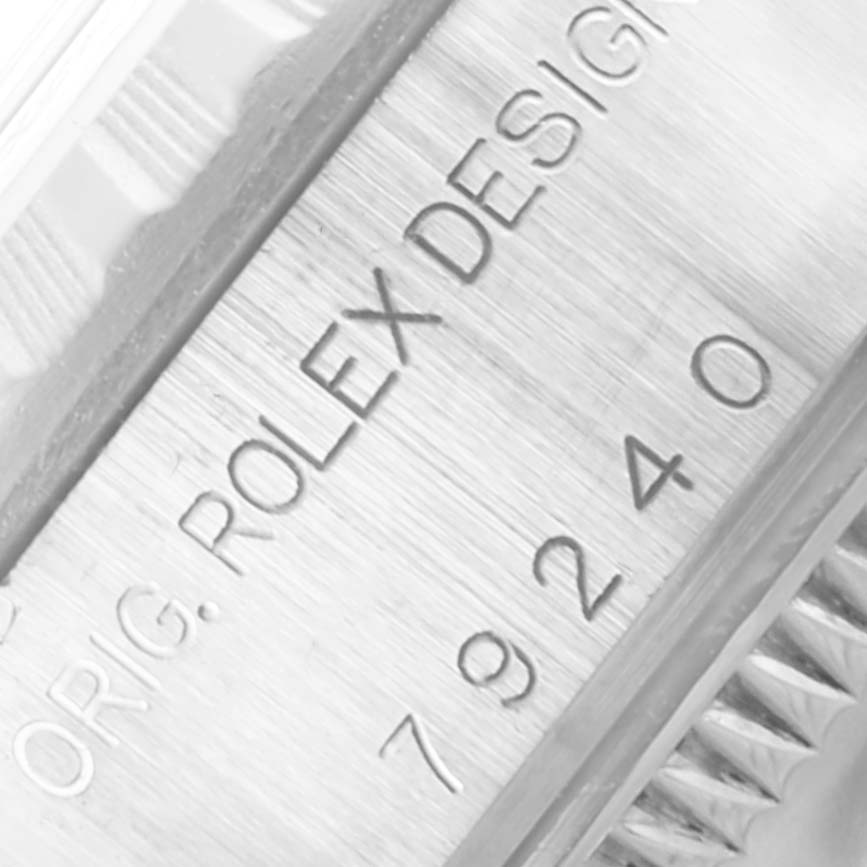 The image shows a close-up view of the side of a Rolex Date 79240 Women's Stainless Steel Pink Dial 79240 Women's Stainless Steel Pink Dial model, displaying part of the case and the engraved model number.