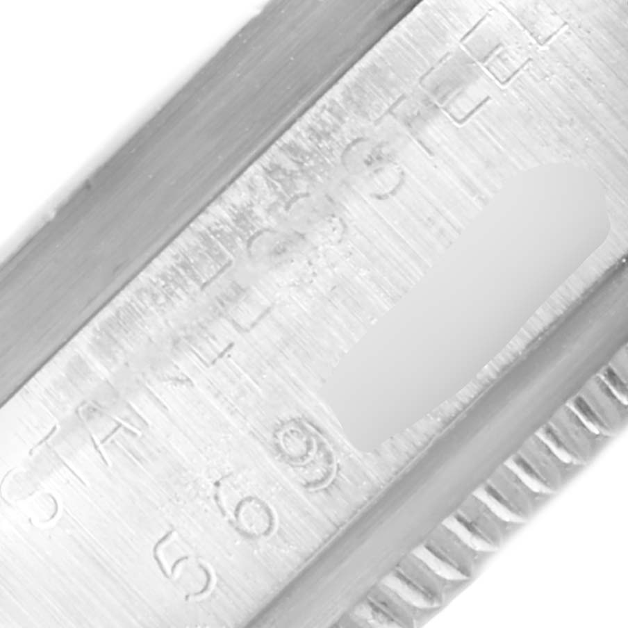 This close-up image shows part of the case and the engraved serial number of the Rolex Vintage Collection 1501 Men's Stainless Steel Black Dial 1501 Men's Stainless Steel Black Dial watch.