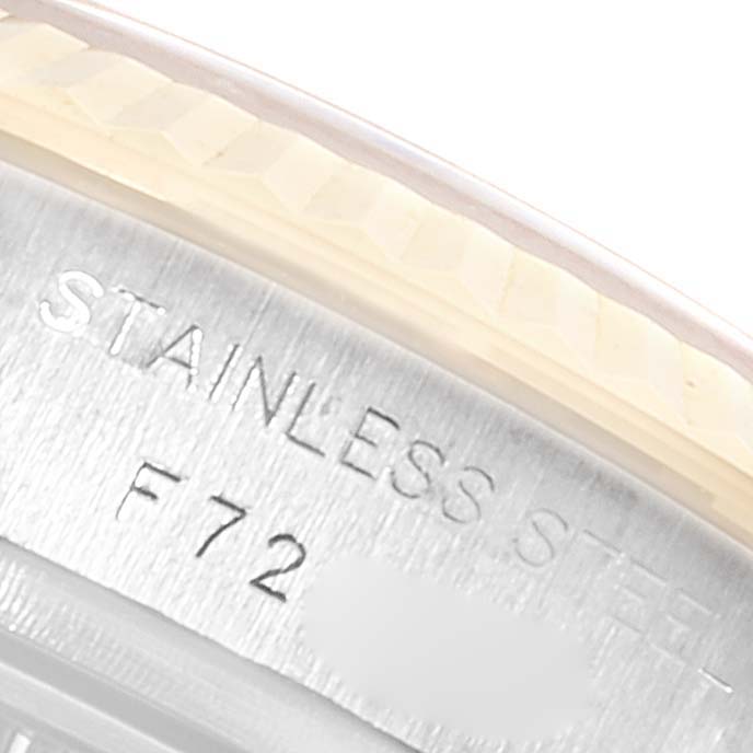 This close-up image shows the edge of the case back and part of the engravings on a Rolex Datejust 179173 Women's Steel and Gold (two tone) White Dial 179173 Women's Steel and Gold (two tone) White Dial watch.