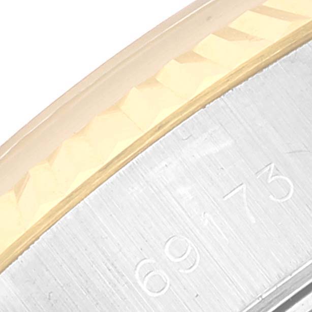 This close-up image shows part of the case and bezel of a Rolex Datejust 69173 Women's Steel and Gold (two tone) Black Dial 69173 Women's Steel and Gold (two tone) Black Dial watch.