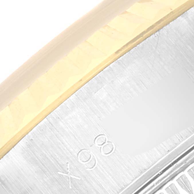 The image shows a close-up angle of a Rolex Datejust 69173 Women's Steel and Gold (two tone) Black Dial 69173 Women's Steel and Gold (two tone) Black Dial watch, highlighting part of the bezel and serial number engraving.