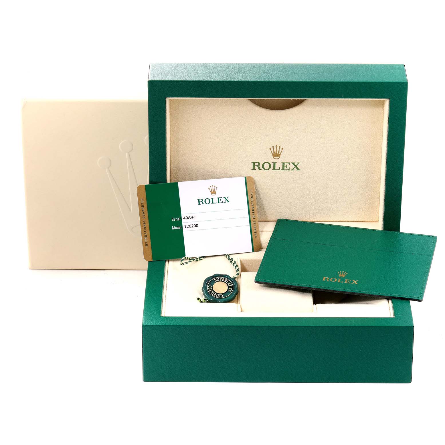 The image shows the open box and accessories of a Rolex Datejust 126200 Men
s Stainless Steel Black Dial 126200 Men
s Stainless Steel Black Dial model, including the warranty card, booklet, and tag.
