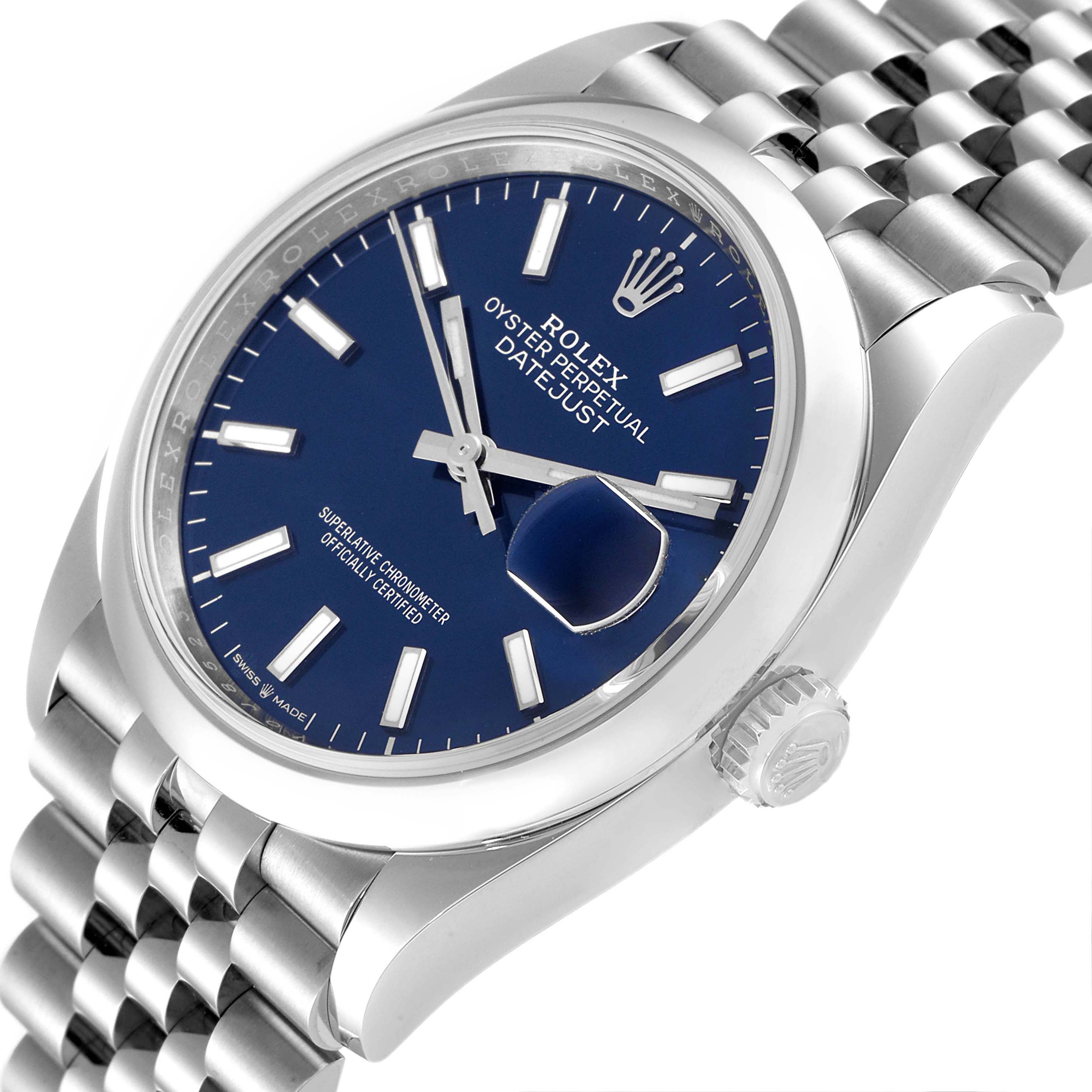 The image shows a close-up angle of a Rolex Datejust 126200 Men's Stainless Steel Blue Dial 126200 Men's Stainless Steel Blue Dial watch, highlighting the dial, bezel, crown, and part of the bracelet.