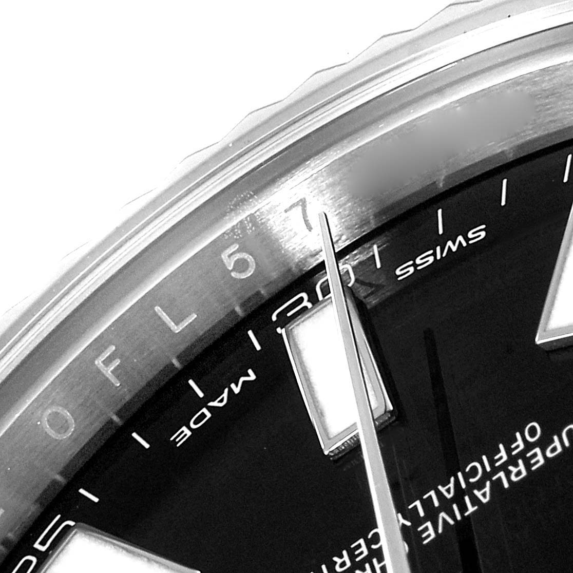 This close-up image of the Rolex Datejust 41 116334 Men's Stainless Steel Black Dial 116334 Men's Stainless Steel Black Dial watch showcases part of the dial, the minute hand, and the bezel.