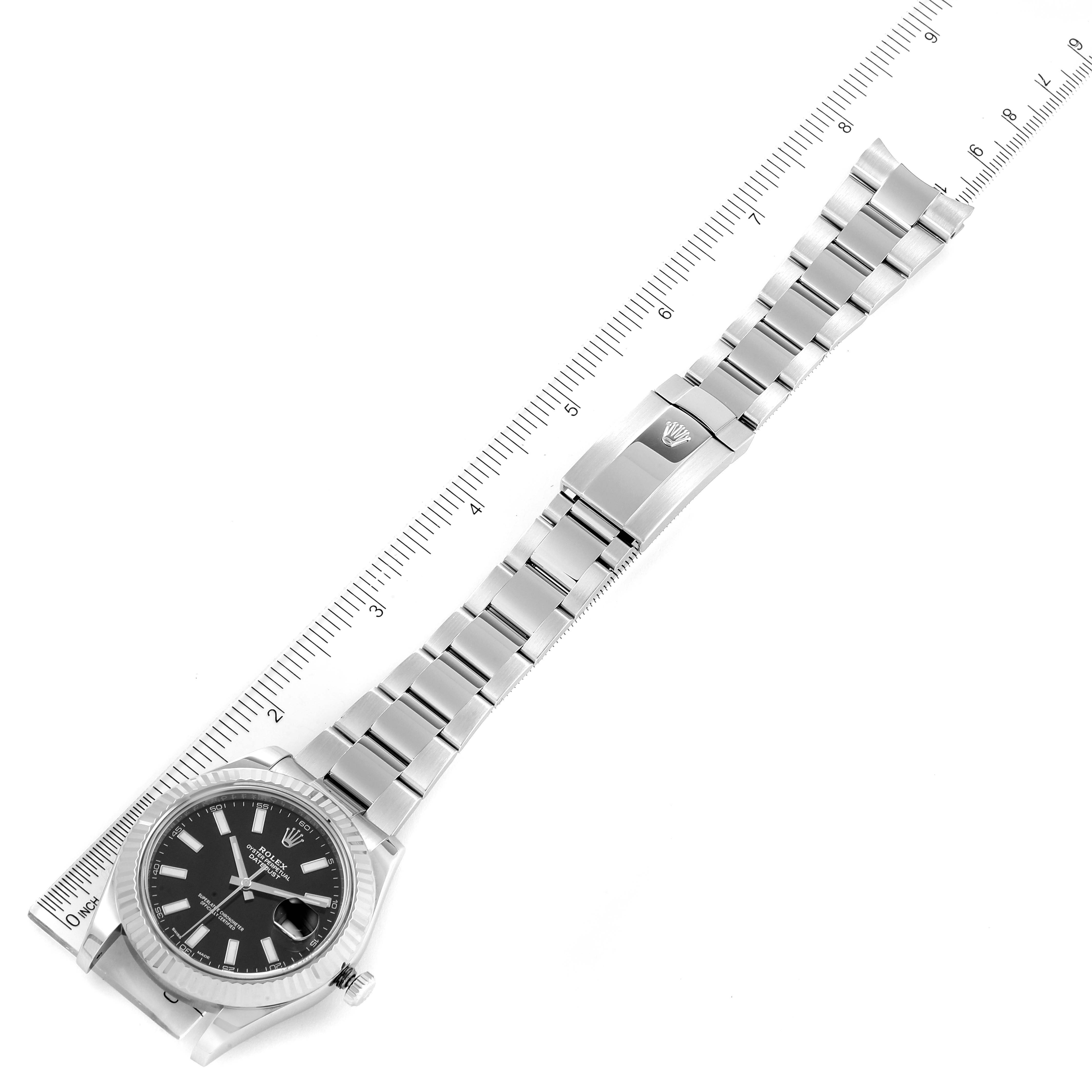 The image shows a Rolex Datejust 41 116334 Men's Stainless Steel Black Dial 116334 Men's Stainless Steel Black Dial watch laid flat with its stainless steel bracelet extended next to a ruler for size reference.