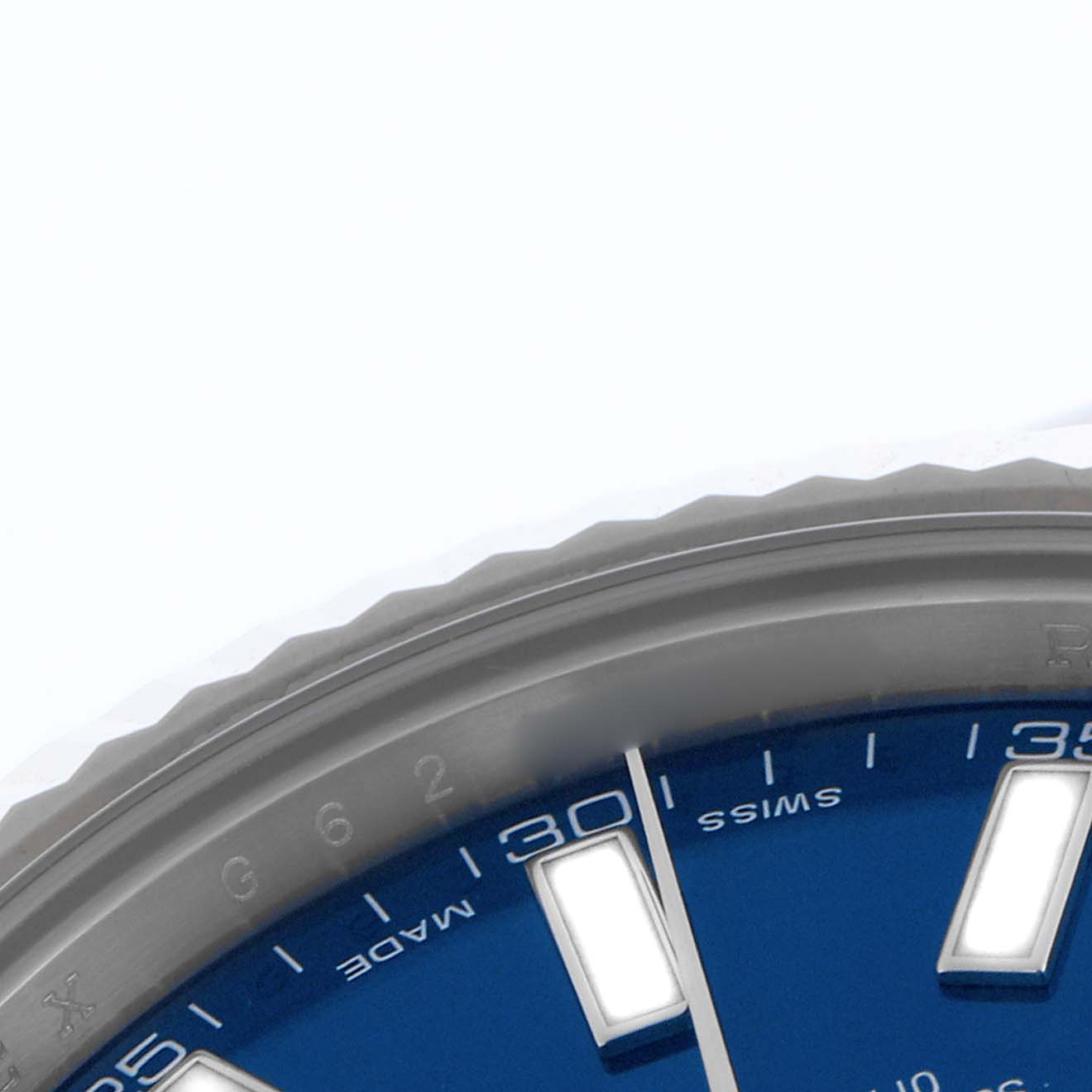 The image shows a close-up of the bezel and part of the blue dial on a Rolex Datejust 41 116334 Men's Stainless Steel Blue Dial 116334 Men's Stainless Steel Blue Dial, focusing on indices and minute markers.