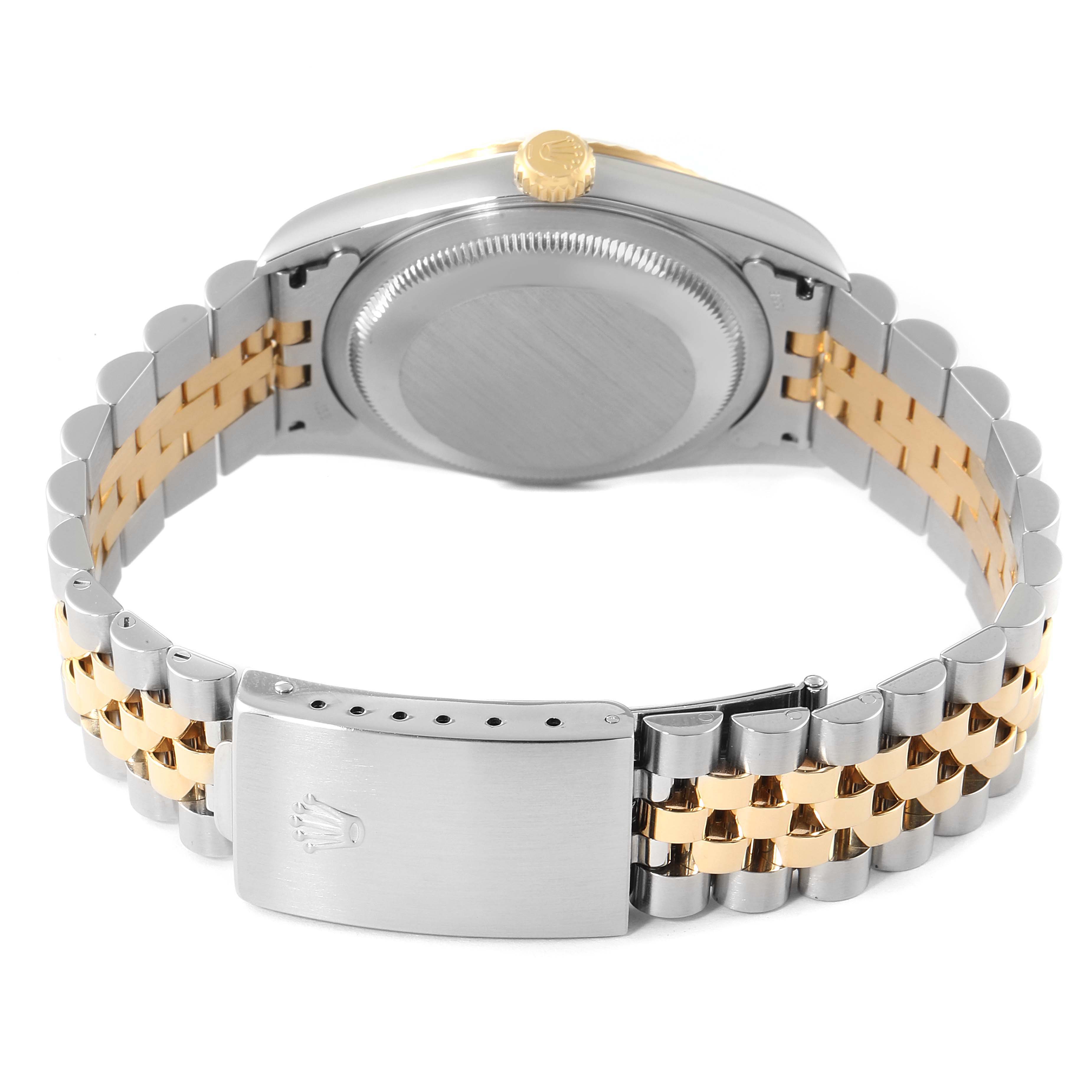 This image shows the backside and clasp of a Rolex Datejust 16233 Men's Steel and Gold (two tone) Black Dial 16233 Men's Steel and Gold (two tone) Black Dial watch, highlighting the two-tone bracelet and case back.