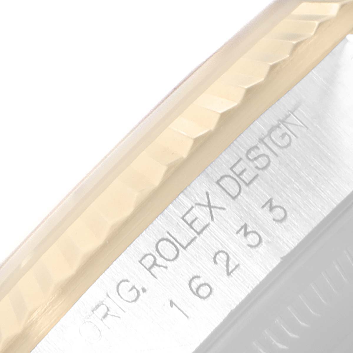 This close-up image shows the side view of the bezel and part of the case of a Rolex Datejust 16233 Men's Steel and Gold (two tone) Black Dial 16233 Men's Steel and Gold (two tone) Black Dial watch.