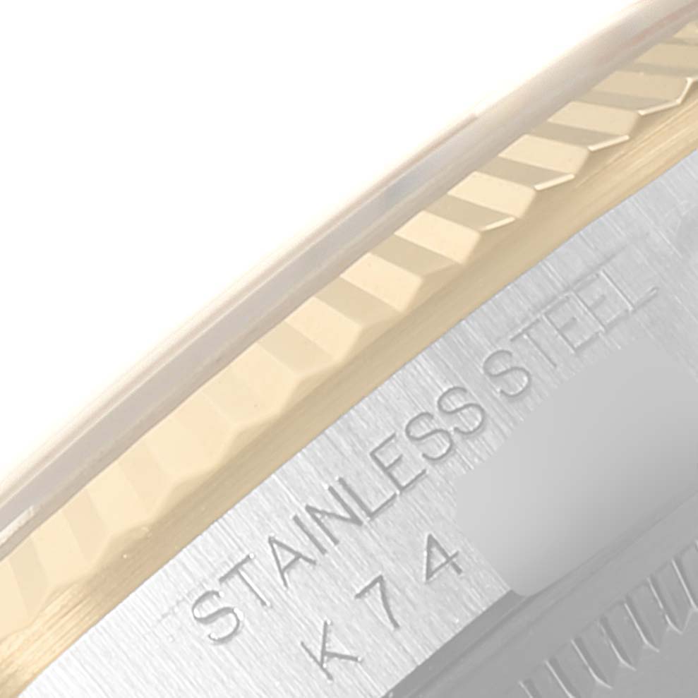 This image shows a close-up of the bezel and part of the stainless steel case of a Rolex Datejust 16233 Men's Steel and Gold (two tone) Black Dial 16233 Men's Steel and Gold (two tone) Black Dial watch.