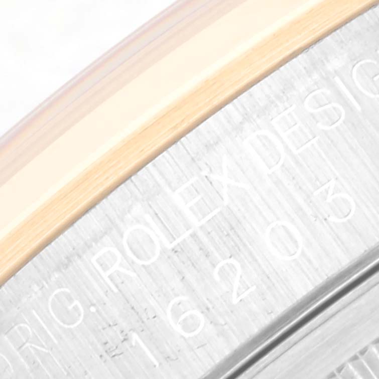 The image shows a close-up of the side engraving on the bezel of a Rolex Datejust 16203 Men's Steel and Gold (two tone) White Dial 16203 Men's Steel and Gold (two tone) White Dial watch.