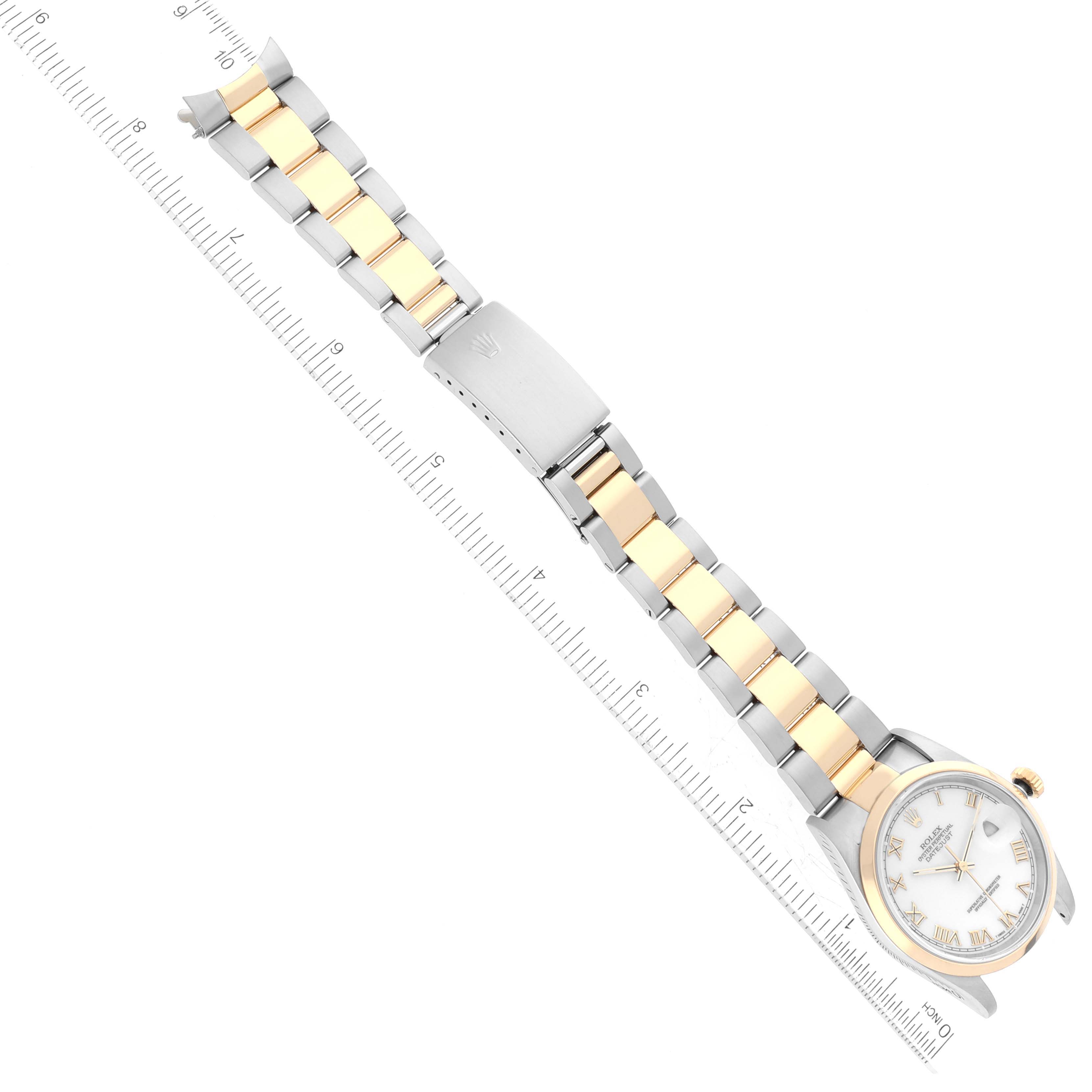 The Rolex Datejust 16203 Men's Steel and Gold (two tone) White Dial 16203 Men's Steel and Gold (two tone) White Dial watch is shown from a top-down angle, highlighting the bracelet and clasp with a ruler alongside.
