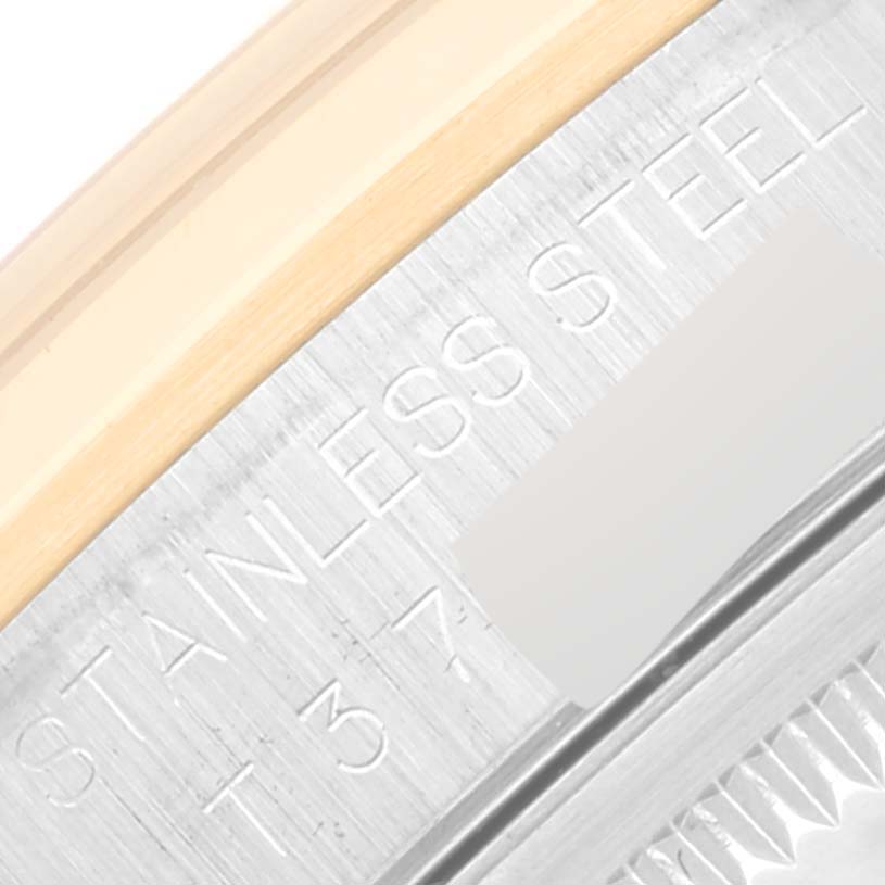 The image shows a close-up of the edge of a Rolex Datejust 16203 Men's Steel and Gold (two tone) White Dial 16203 Men's Steel and Gold (two tone) White Dial watch, highlighting the "Stainless Steel" engraving.