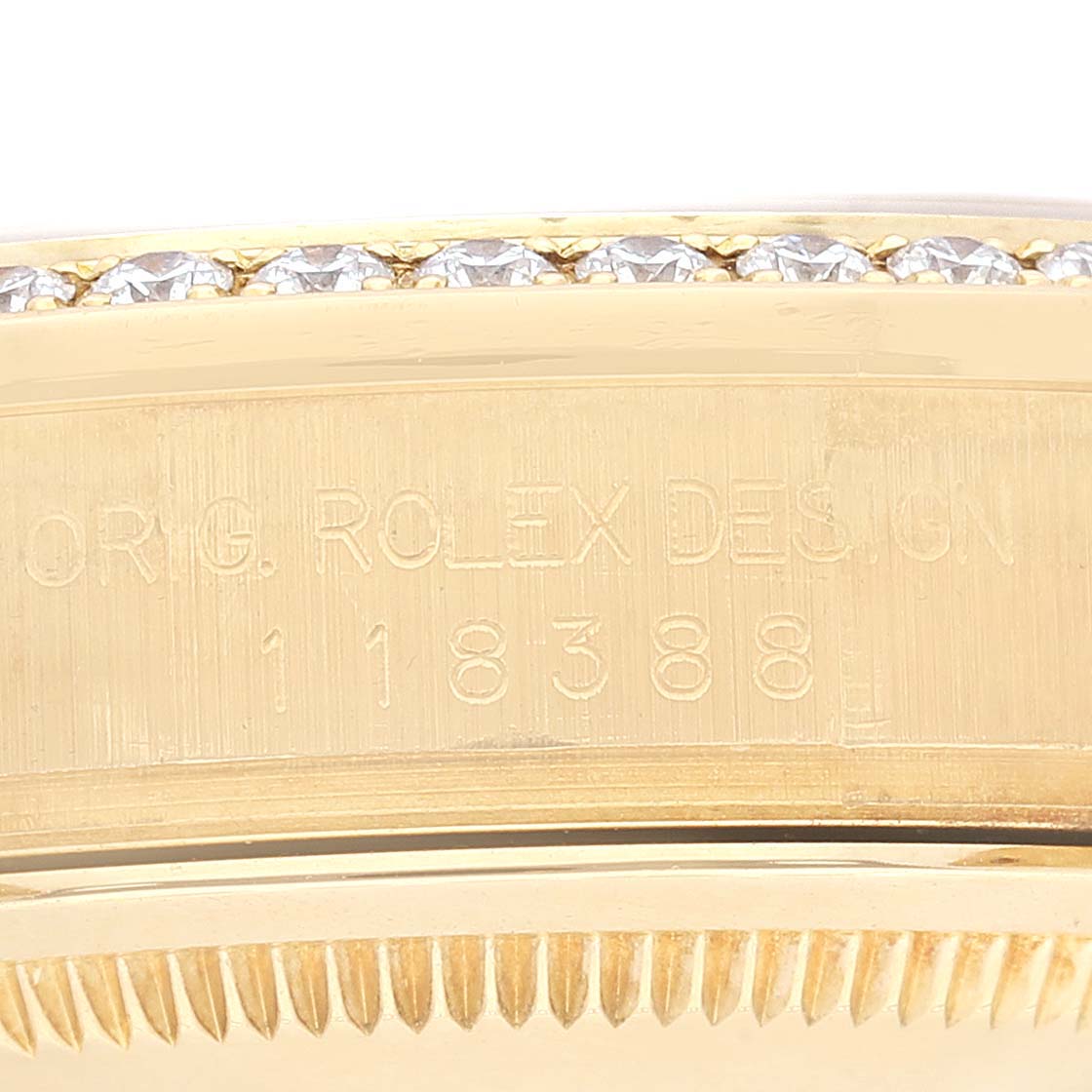 The image shows a close-up of the side of a Rolex President 118388 Men's Yellow Gold Champagne Dial 118388 Men's Yellow Gold Champagne Dial watch, highlighting the model number and diamond bezel.