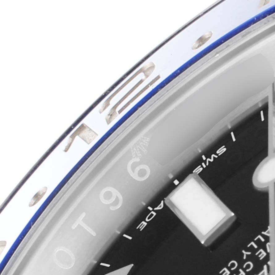 This image shows a close-up angle of the bezel and part of the dial of the Rolex GMT-Master 116710 Men
s Stainless Steel Black Dial 116710 Men
s Stainless Steel Black Dial watch.