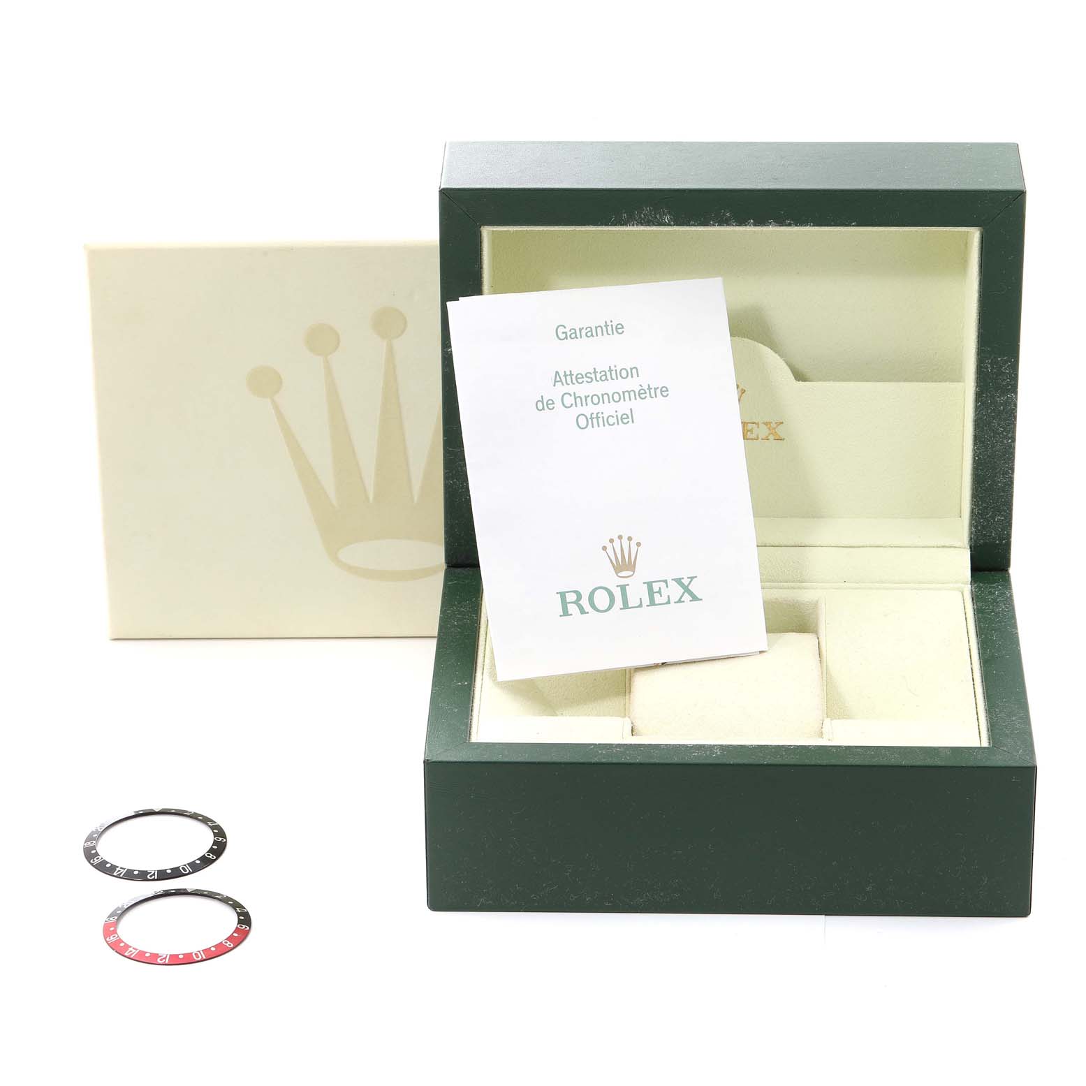 This image shows a Rolex GMT-Master 16710 Men
s Stainless Steel Black Dial 16710 Men
s Stainless Steel Black Dial watch box with warranty card and two extra bezels.