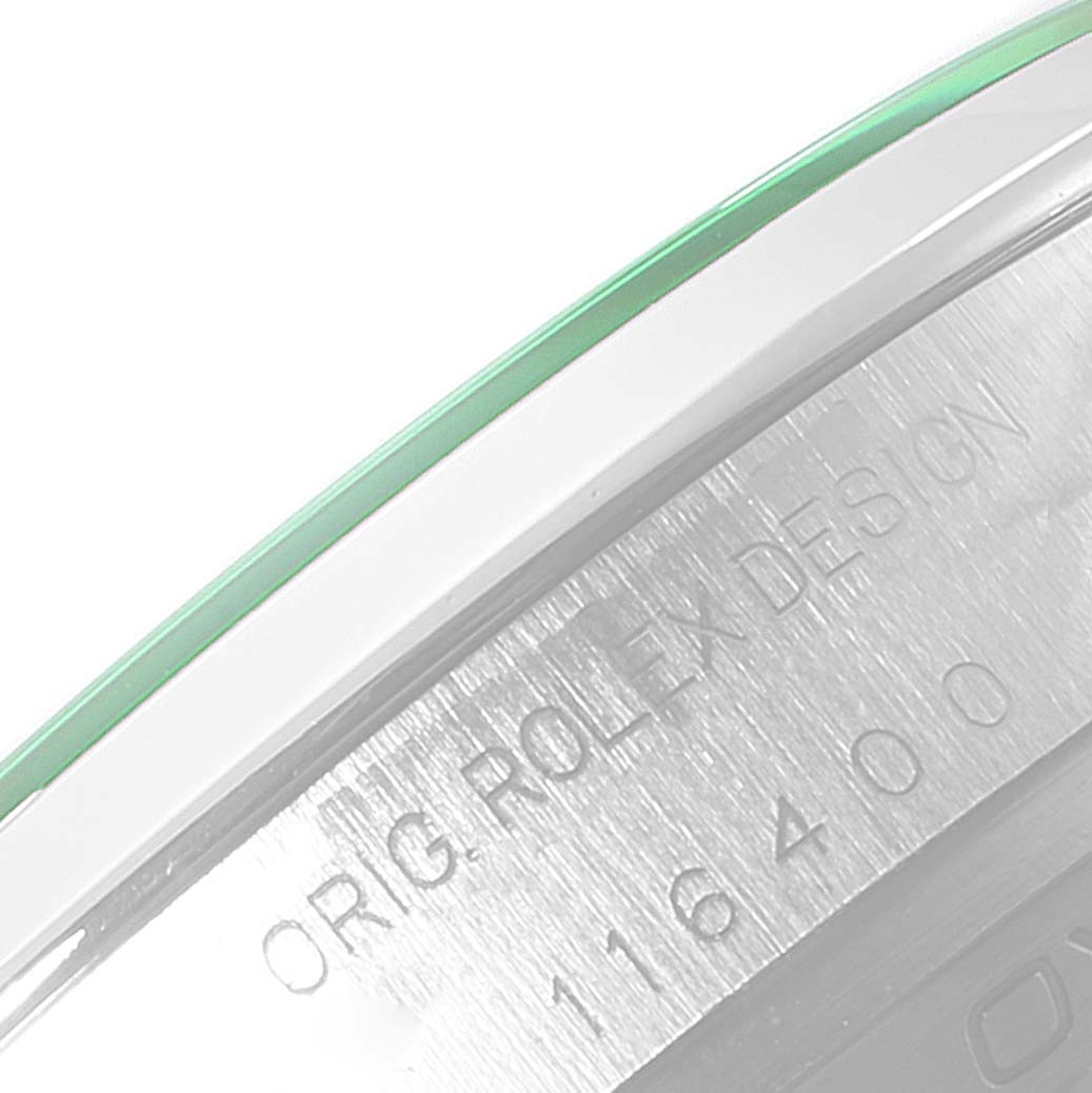 This close-up image shows the engraved case of a Rolex Milgauss 116400V Men's Stainless Steel Black Dial 116400V Men's Stainless Steel Black Dial watch, along with part of the green-tinted crystal.