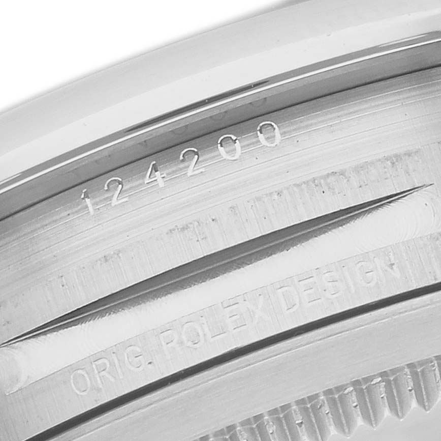 This image shows a close-up of the side case with the engraved reference number "124200" and "ORIG. ROLEX DESIGN" of the Rolex Oyster Perpetual 124200 Men's Stainless Steel Silver Dial 124200 Men's Stainless Steel Silver Dial watch.