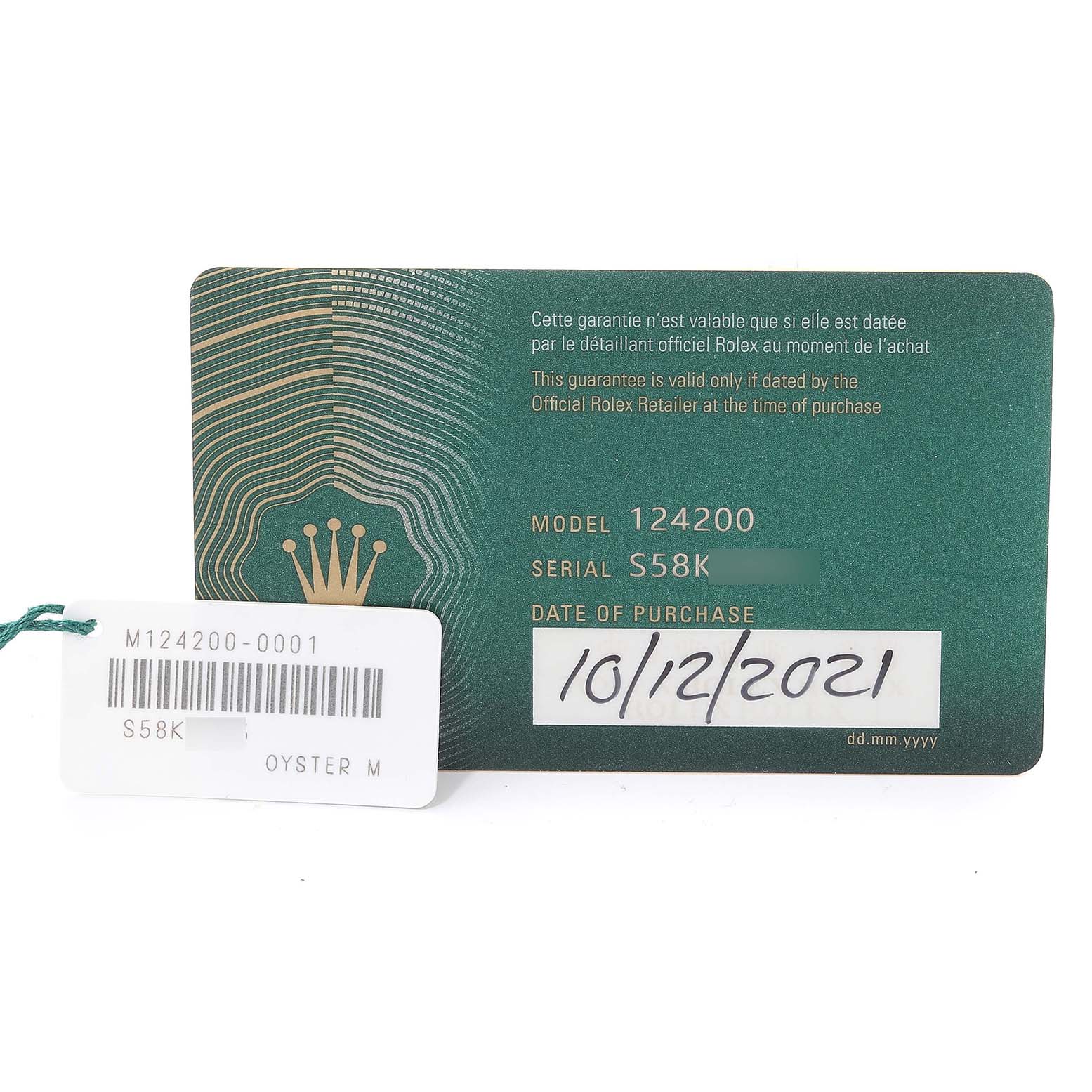 The image shows the green guarantee card and a white tag of a Rolex Oyster Perpetual 124200 Men's Stainless Steel Silver Dial 124200 Men's Stainless Steel Silver Dial model 124200 watch.