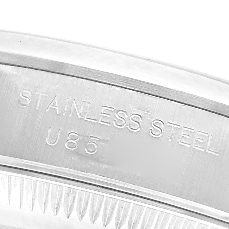 The image shows a close-up of the stainless steel case edge of a Rolex Oyster Perpetual 67180 Women's Stainless Steel Black Dial 67180 Women's Stainless Steel Black Dial watch.