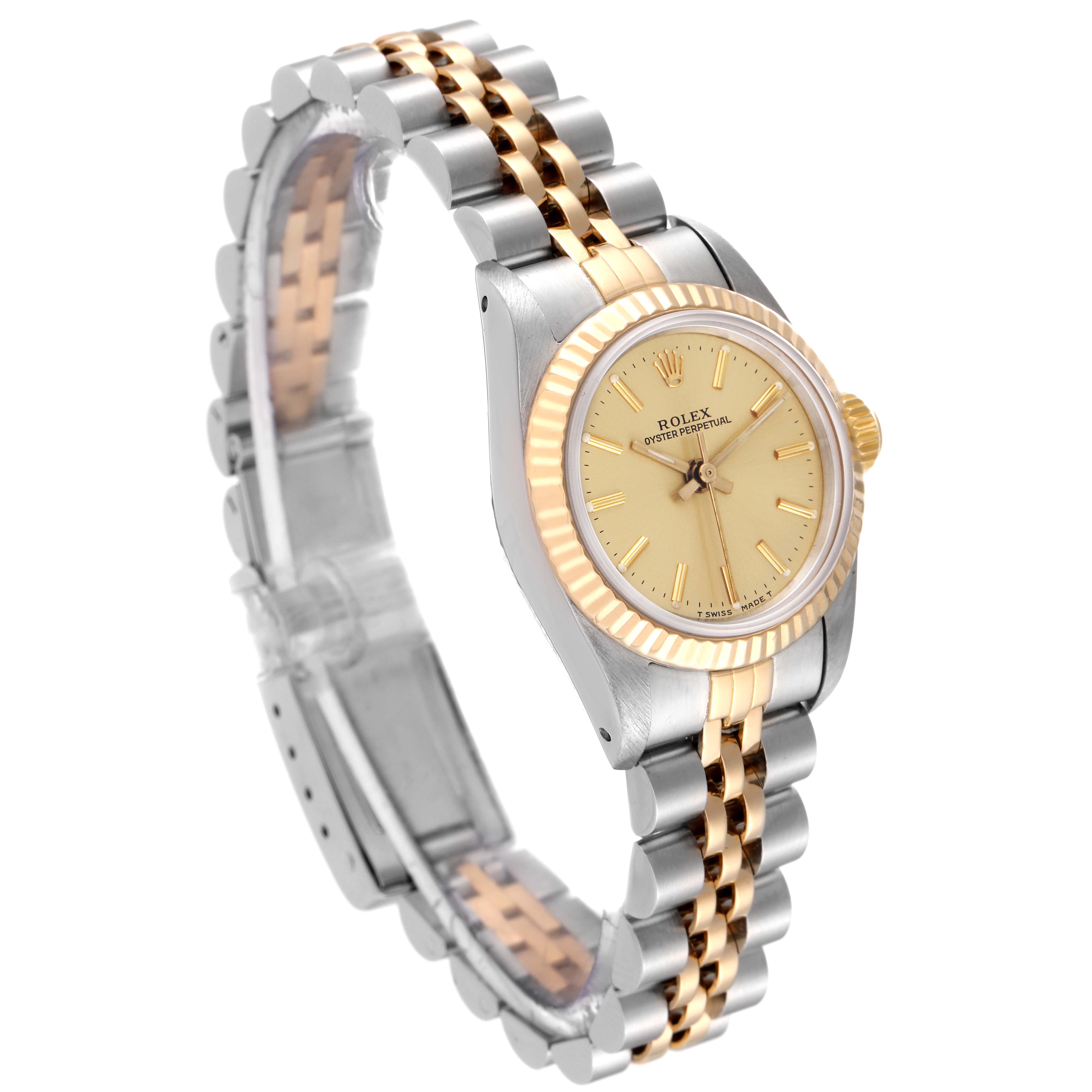 The Rolex Oyster Perpetual 67193 Women's Steel and Gold (two tone) Champagne Dial 67193 Women's Steel and Gold (two tone) Champagne Dial watch is shown at a three-quarter angle, displaying its dial, bezel, and two-tone bracelet.