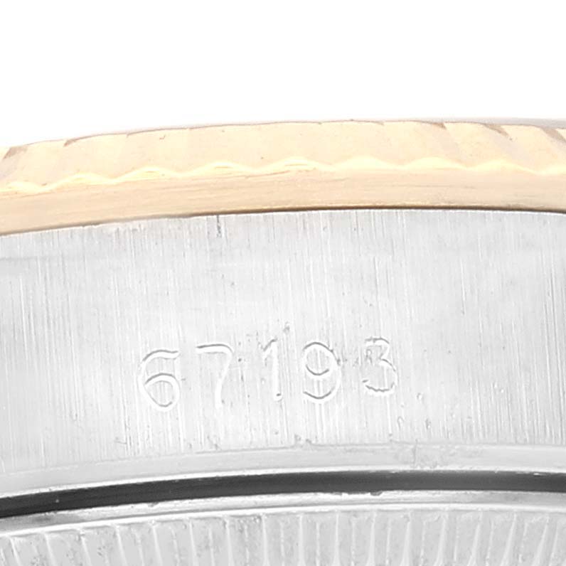 This close-up image shows the case side and engraved reference number of a Rolex Oyster Perpetual 67193 Women's Steel and Gold (two tone) Champagne Dial 67193 Women's Steel and Gold (two tone) Champagne Dial watch.