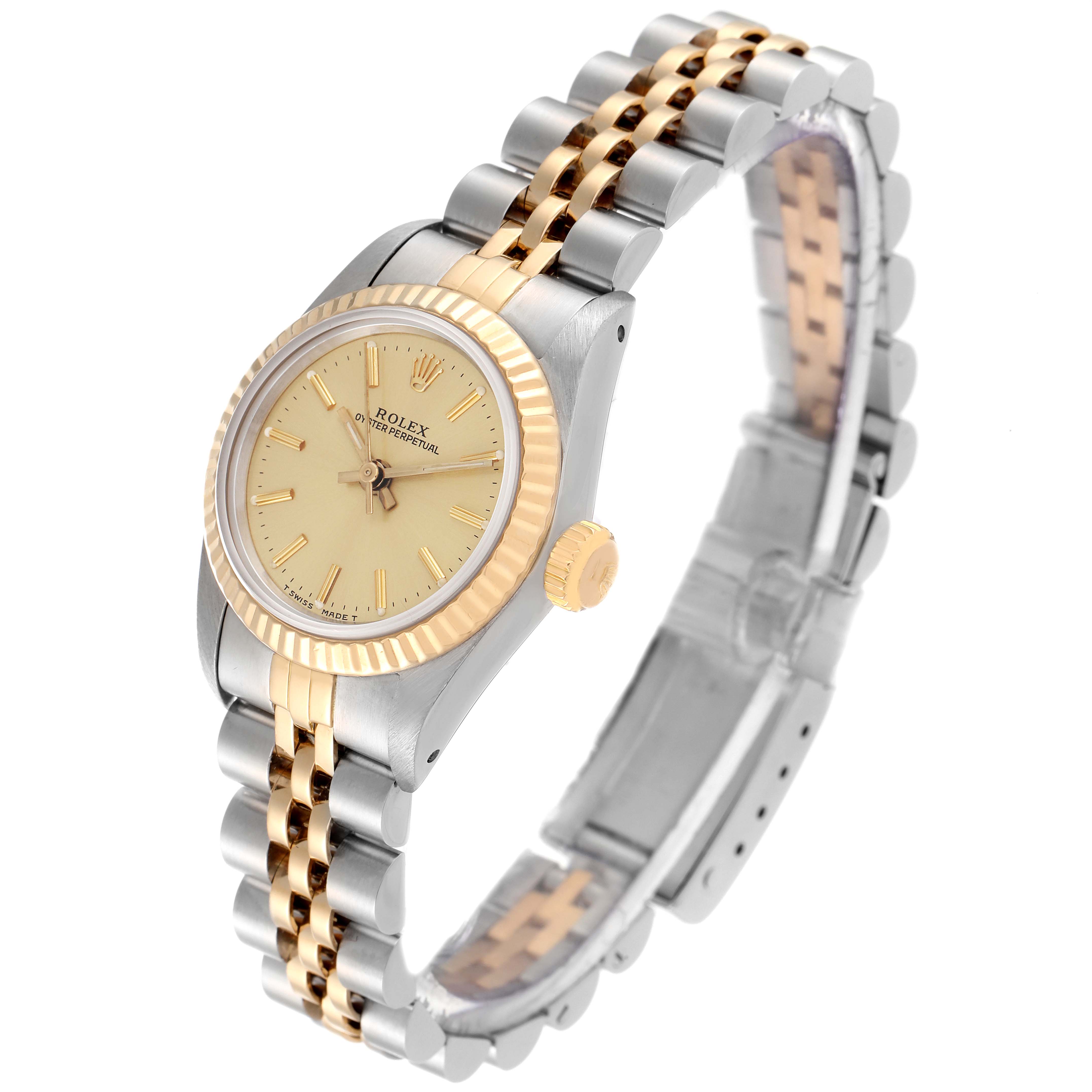 This image shows a Rolex Oyster Perpetual 67193 Women's Steel and Gold (two tone) Champagne Dial 67193 Women's Steel and Gold (two tone) Champagne Dial watch from a three-quarter angle, displaying its dial, bezel, and two-tone bracelet.