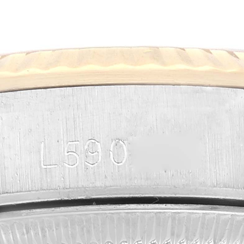 This close-up image shows the side view of the bezel and part of the casing of the Rolex Oyster Perpetual 67193 Women's Steel and Gold (two tone) Champagne Dial 67193 Women's Steel and Gold (two tone) Champagne Dial watch.