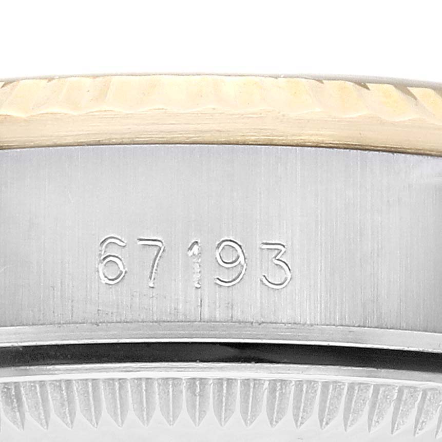 This image shows a close-up of the side case and bezel of a Rolex Oyster Perpetual 67193 Women's Steel and Gold (two tone) Champagne Dial 67193 Women's Steel and Gold (two tone) Champagne Dial watch with the model number 67193 engraved.