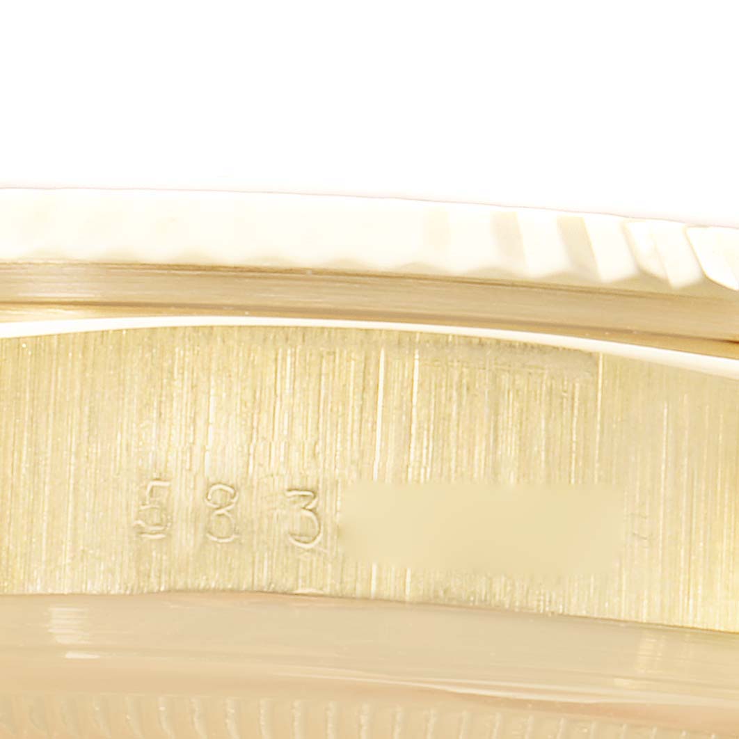 This close-up image shows part of the case side of a Rolex President 18038 Men's Yellow Gold White Dial 18038 Men's Yellow Gold White Dial model, including serial numbers.