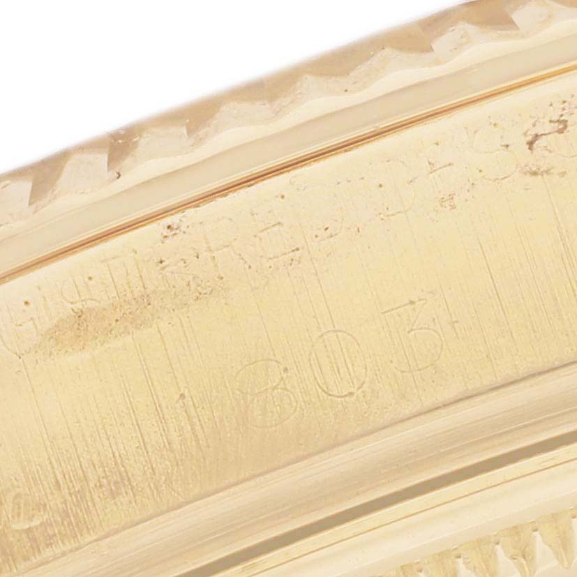 This close-up image shows part of the bezel and part of the engraving on the case of the Rolex Vintage Collection 1803 Men's Yellow Gold Silver Dial 1803 Men's Yellow Gold Silver Dial watch.
