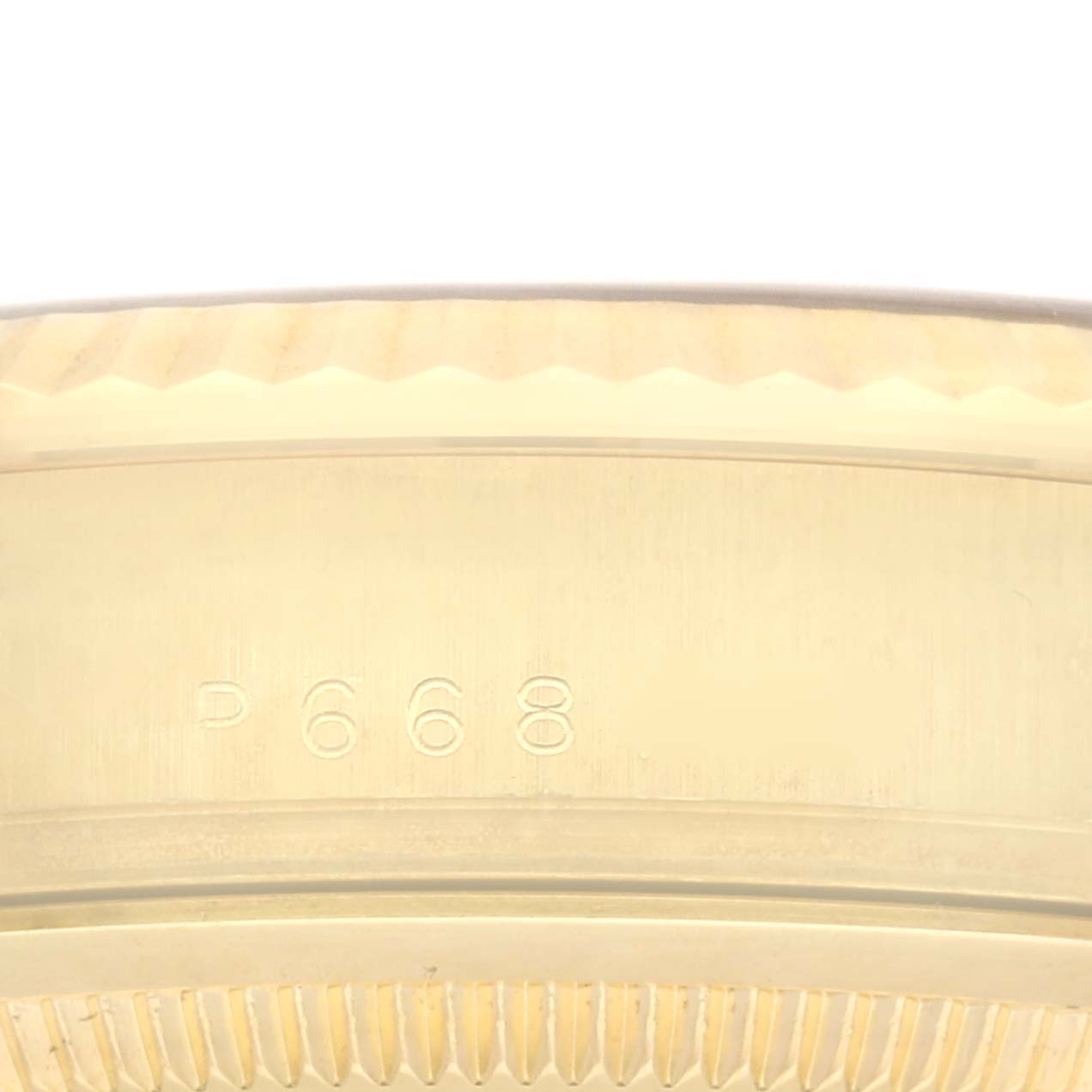 The image shows a close-up of the serial number and fluted bezel edge of a Rolex President 118238 Men's Yellow Gold Blue Dial 118238 Men's Yellow Gold Blue Dial model watch.
