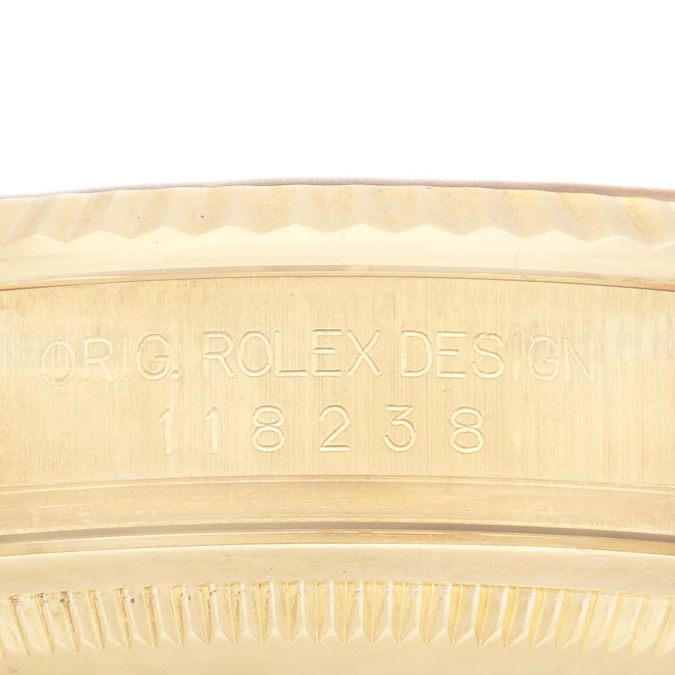 This image shows an engraved close-up view of a Rolex President 118238 Men's Yellow Gold Blue Dial 118238 Men's Yellow Gold Blue Dial model watch's case side.