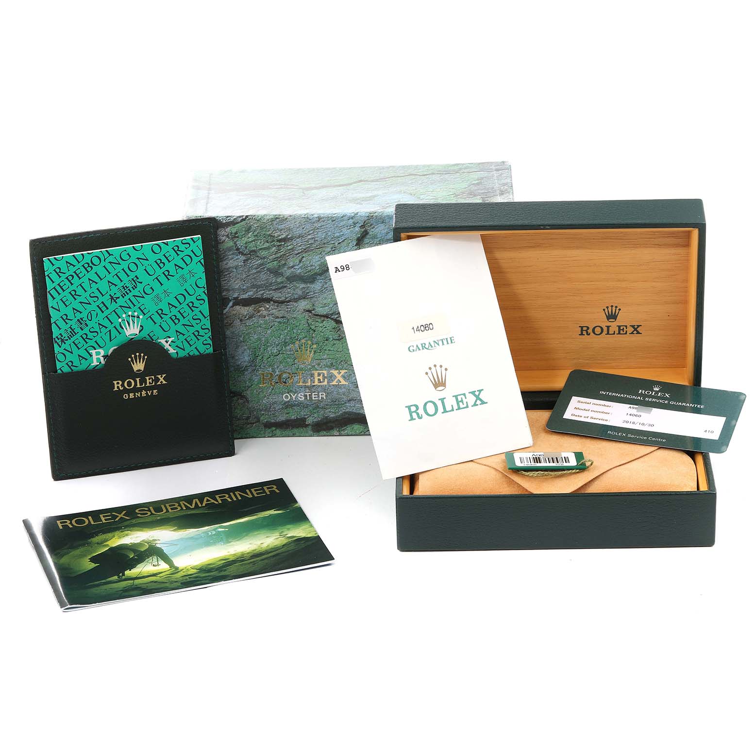 This image shows the packaging materials, warranty card, manuals, and boxes for a Rolex Submariner 14060 Men's Stainless Steel Black Dial 14060 Men's Stainless Steel Black Dial watch.