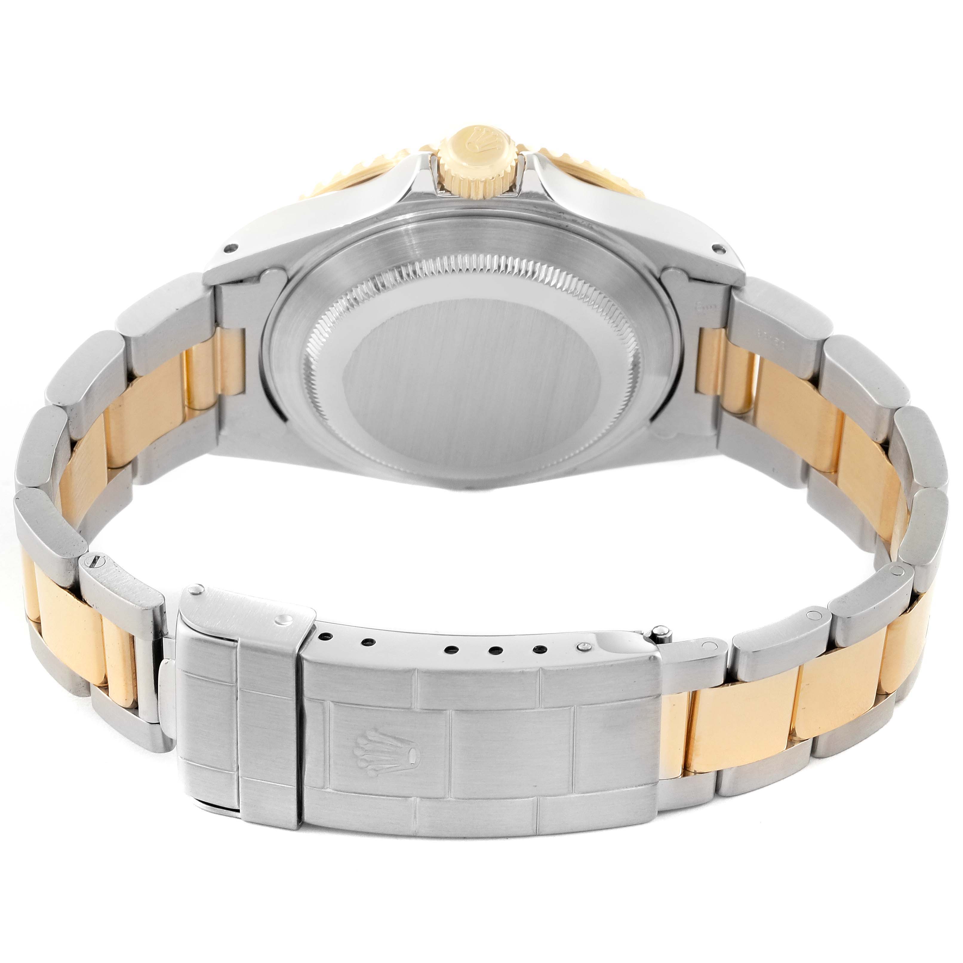 The image shows the back view of a Rolex Submariner 16613 Men's Steel and Gold (two tone) Black Dial 16613 Men's Steel and Gold (two tone) Black Dial, highlighting its case back, crown, and two-tone bracelet with clasp.