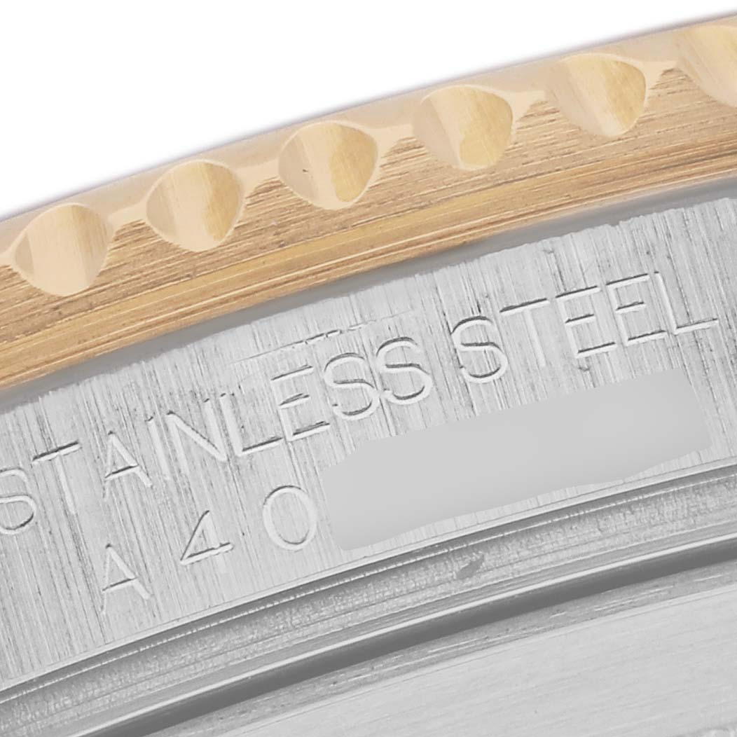 The image shows a close-up of the stainless steel engraved case and ridged bezel of a Rolex Submariner 16613 Men's Steel and Gold (two tone) Black Dial 16613 Men's Steel and Gold (two tone) Black Dial watch.