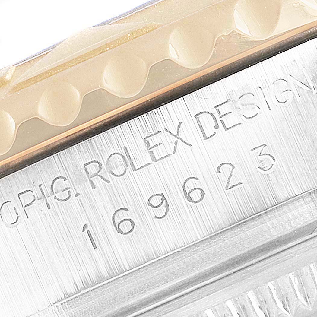 This close-up image shows the engraved model number and part of the bezel of the Rolex Yacht-Master 169623 Women's Steel and Gold (two tone) White Dial 169623 Women's Steel and Gold (two tone) White Dial watch.