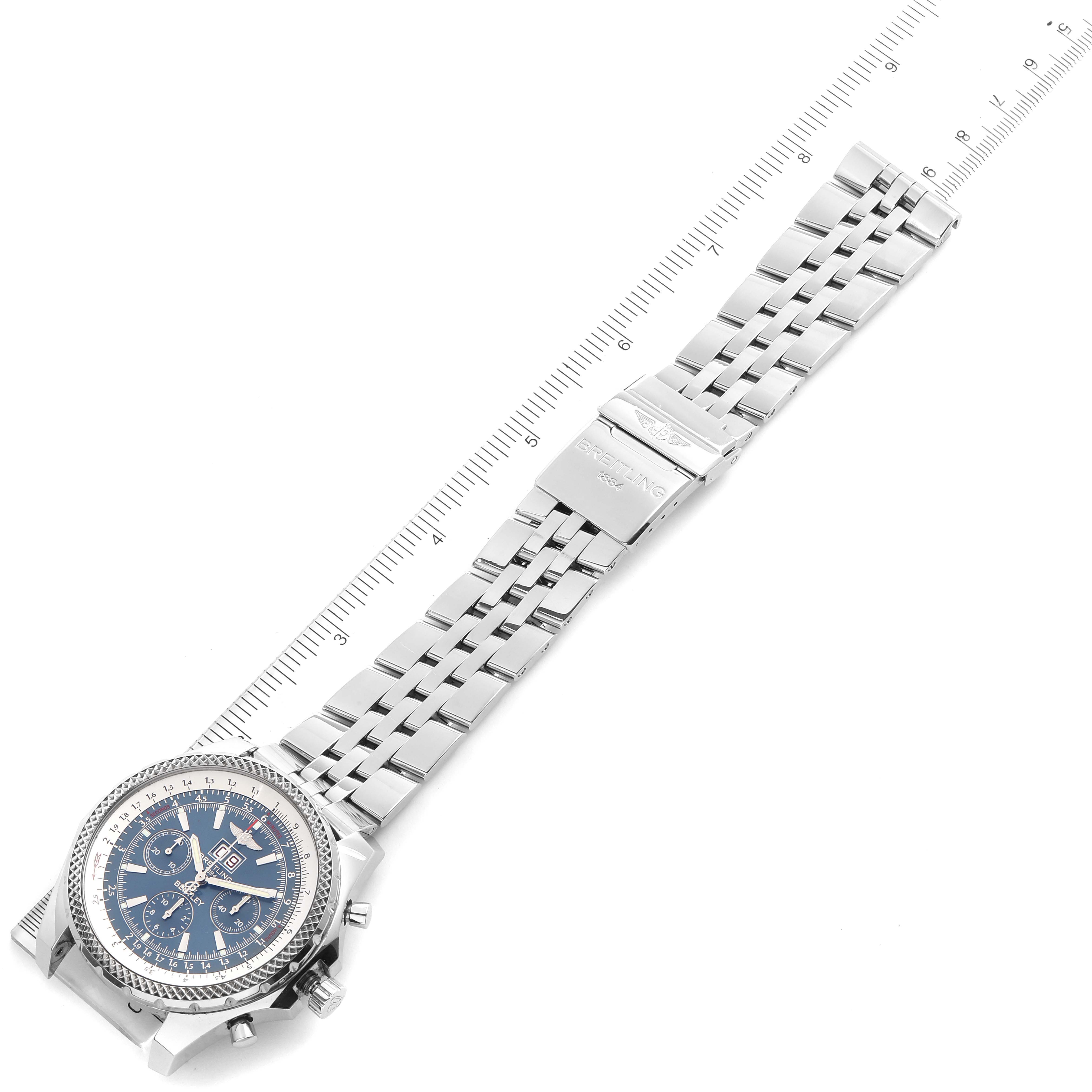 The image shows a top-down view of the Breitling Bentley A44362 Men's Stainless Steel Blue Dial A44362 Men's Stainless Steel Blue Dial watch, highlighting its face, bracelet, and clasp alongside a ruler.