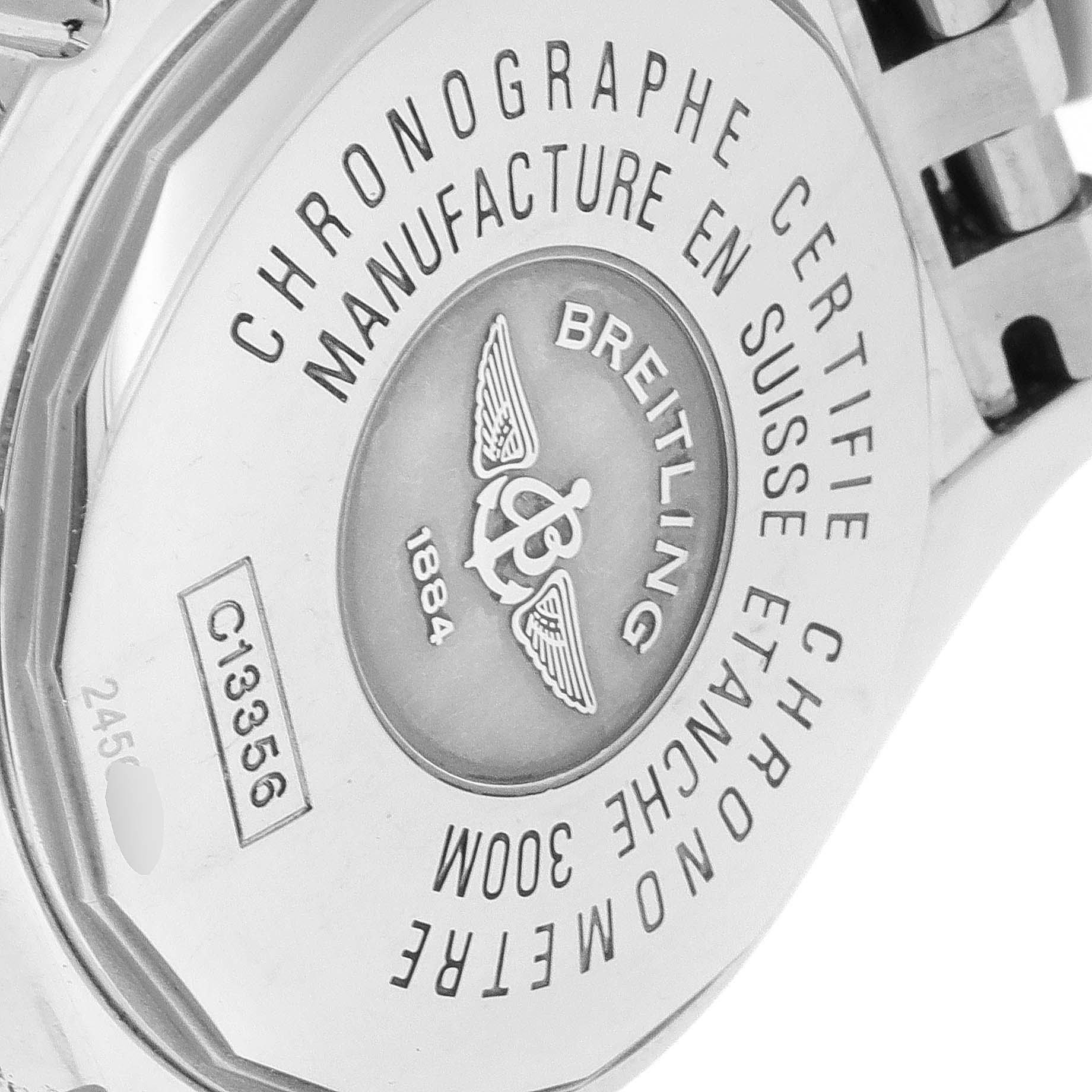 The image shows the back casing of a Breitling Chronomat C13356 Men's Steel and Gold (two tone) White Dial C13356 Men's Steel and Gold (two tone) White Dial watch, highlighting its engravings and metal bracelet attachment.