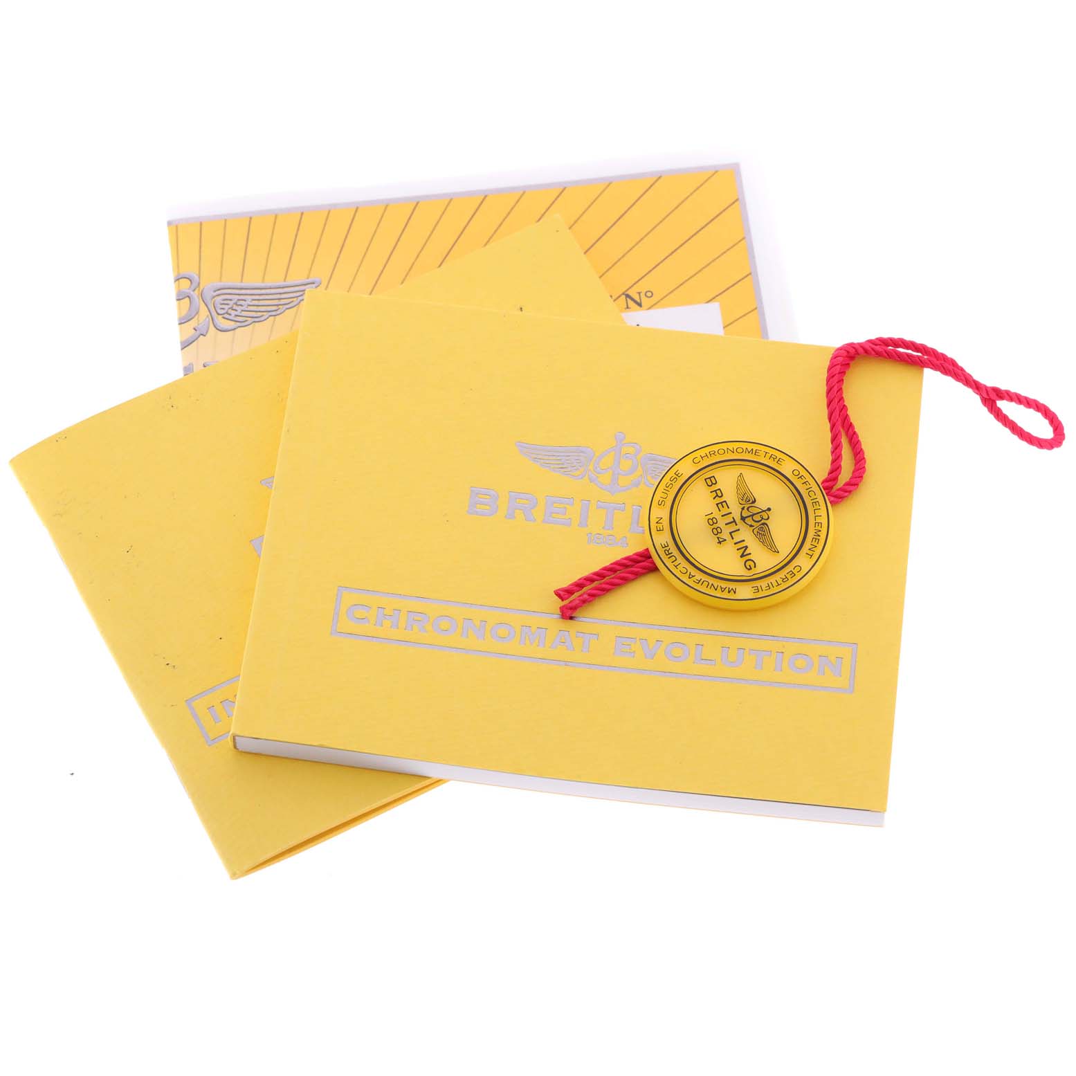 The image shows the yellow manual and certification booklet for the Breitling Chronomat C13356 Men's Steel and Gold (two tone) White Dial C13356 Men's Steel and Gold (two tone) White Dial Evolution watch.
