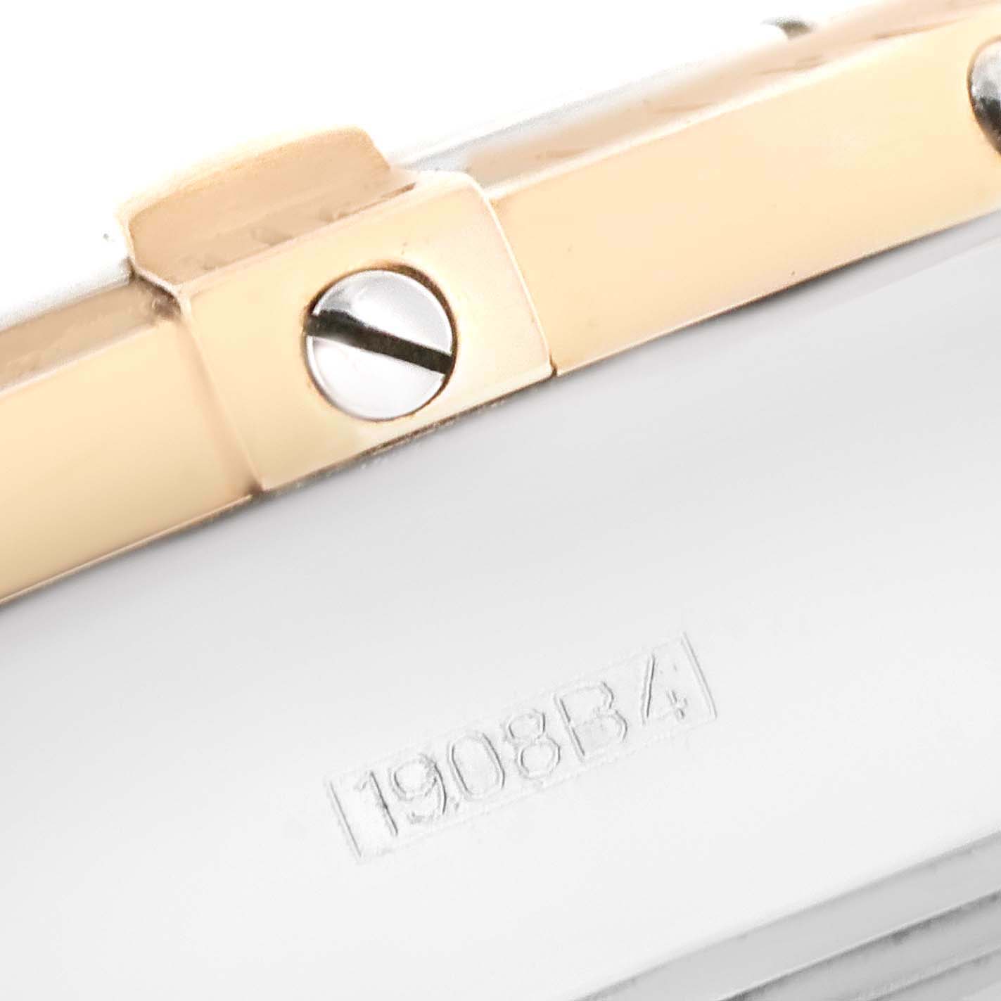 The image shows a close-up angle of a Breitling Chronomat C13356 Men's Steel and Gold (two tone) White Dial C13356 Men's Steel and Gold (two tone) White Dial watch, specifically a section of the case with a visible screw and a serial number.