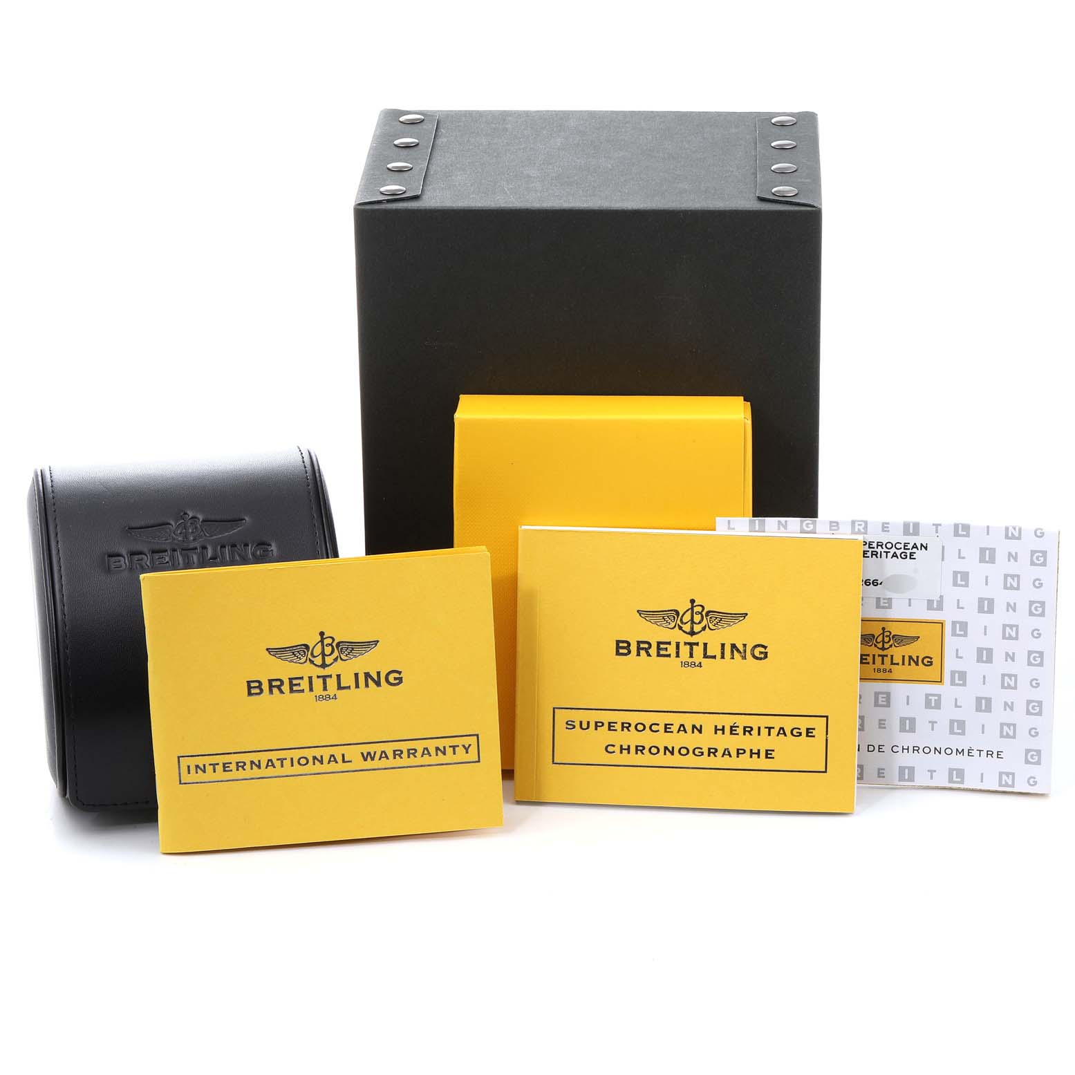The image shows boxes and manuals for the Breitling Superocean A13320 Men
s Stainless Steel Silver Dial A13320 Men
s Stainless Steel Silver Dial watch, including an international warranty booklet.