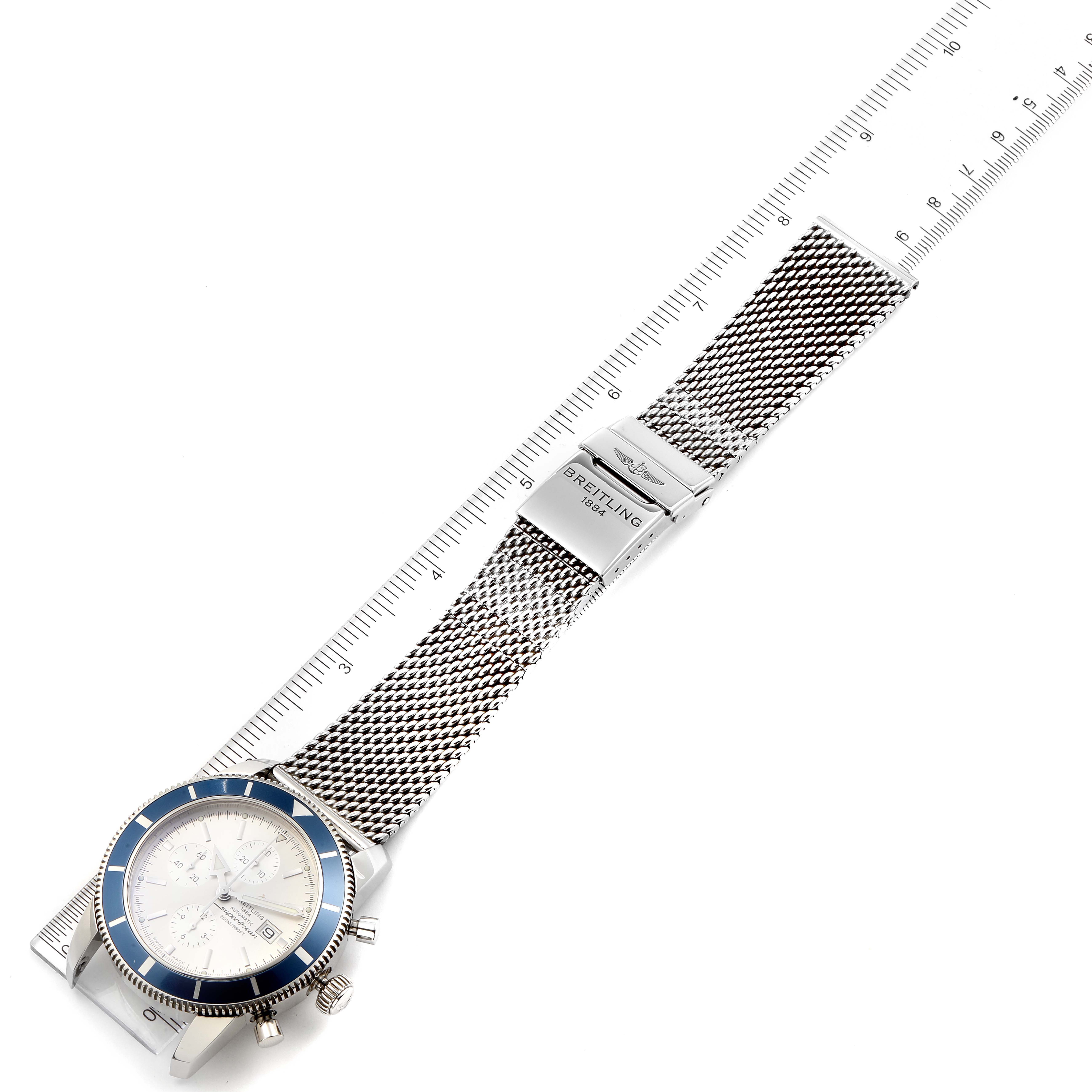 The Breitling Superocean A13320 Men
s Stainless Steel Silver Dial A13320 Men
s Stainless Steel Silver Dial watch is shown from an overhead angle, highlighting the face, bezel, and mesh strap with a clasp.