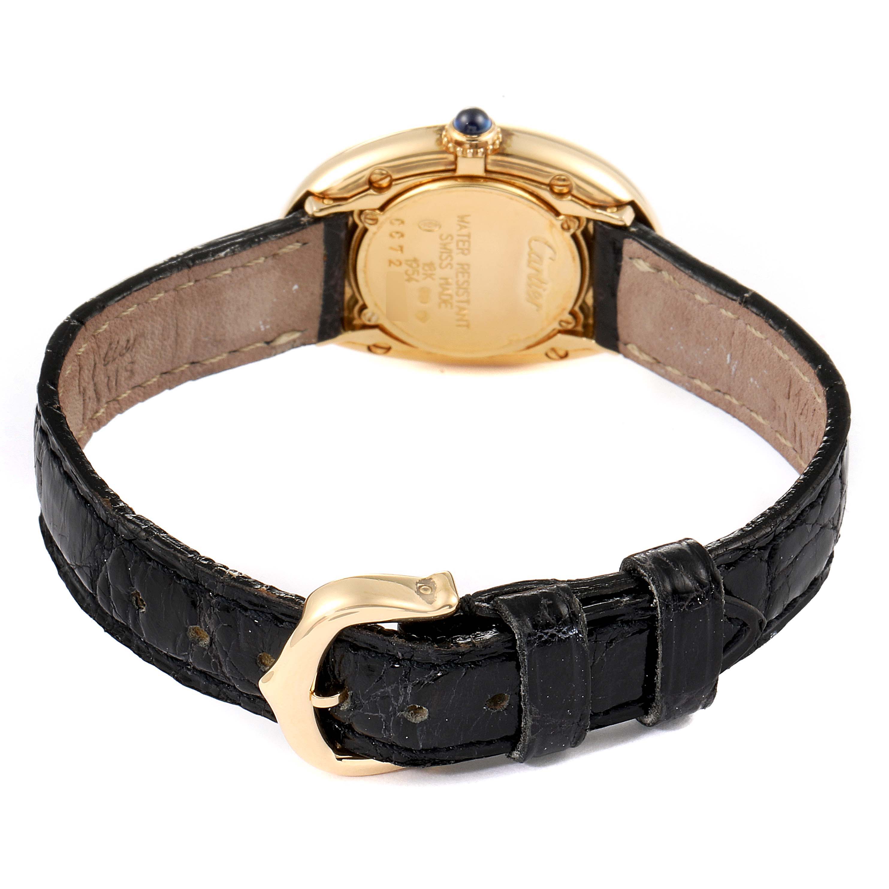 The image shows the back view of the Cartier Baignoire 1954 Women's Yellow Gold Silver Dial 1954 Women's Yellow Gold Silver Dial watch, highlighting its gold case, black leather strap, and buckle.