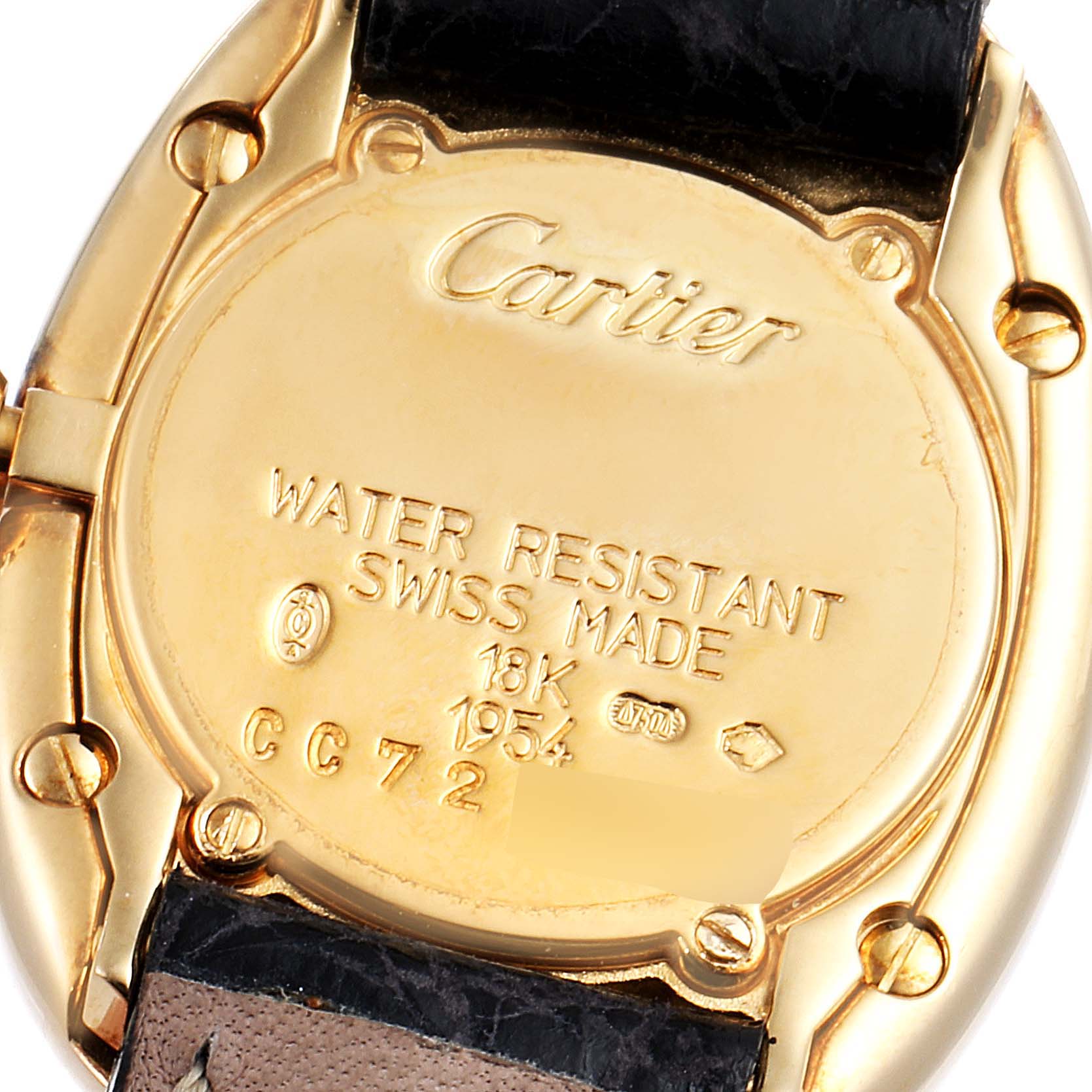 This image shows the back of a Cartier Baignoire 1954 Women's Yellow Gold Silver Dial 1954 Women's Yellow Gold Silver Dial watch, highlighting its inscriptions and black leather strap part.