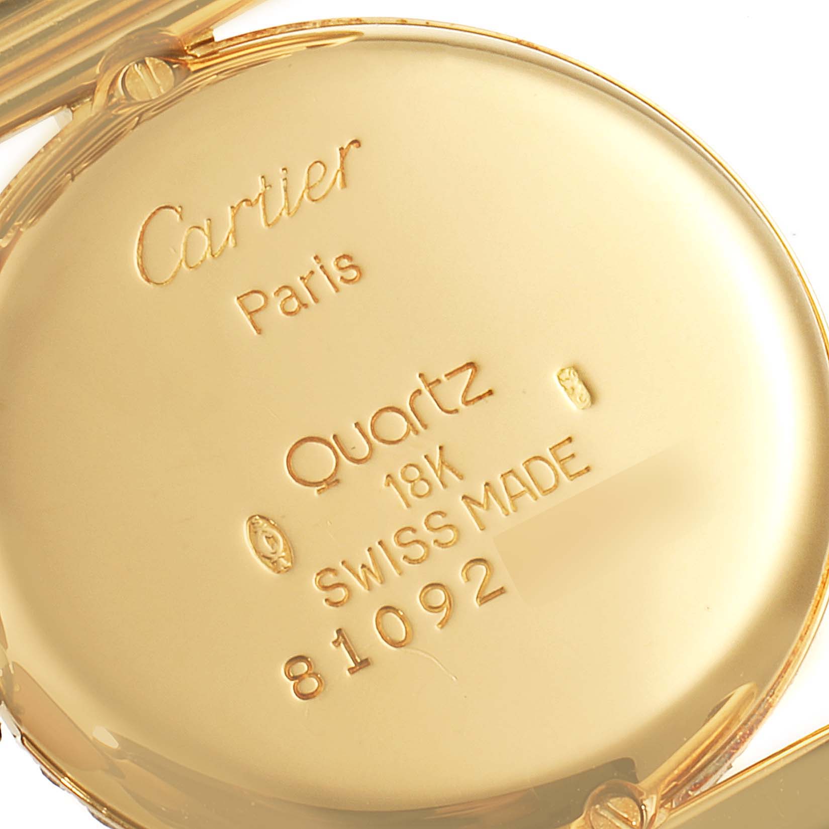 This image shows the back case of the Cartier Colisee Women's Yellow Gold Champagne Dial Women's Yellow Gold Champagne Dial model watch, highlighting its inscriptions and gold material.